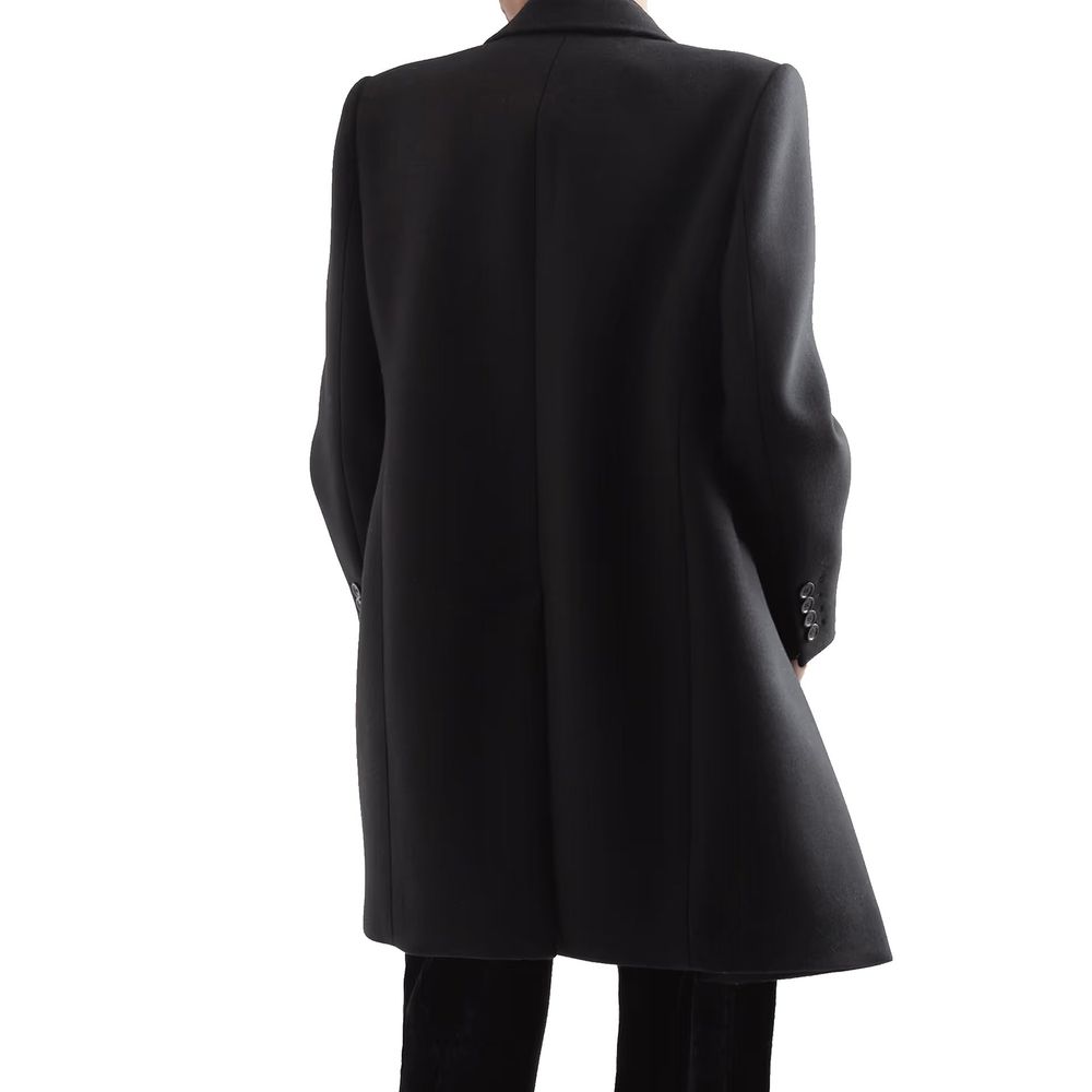 Experience the exquisite Saint Laurent Black Wool Coat, crafted from 100% wool with a luxurious cupro silk lining, embodying timeless elegance and modern sophistication.
