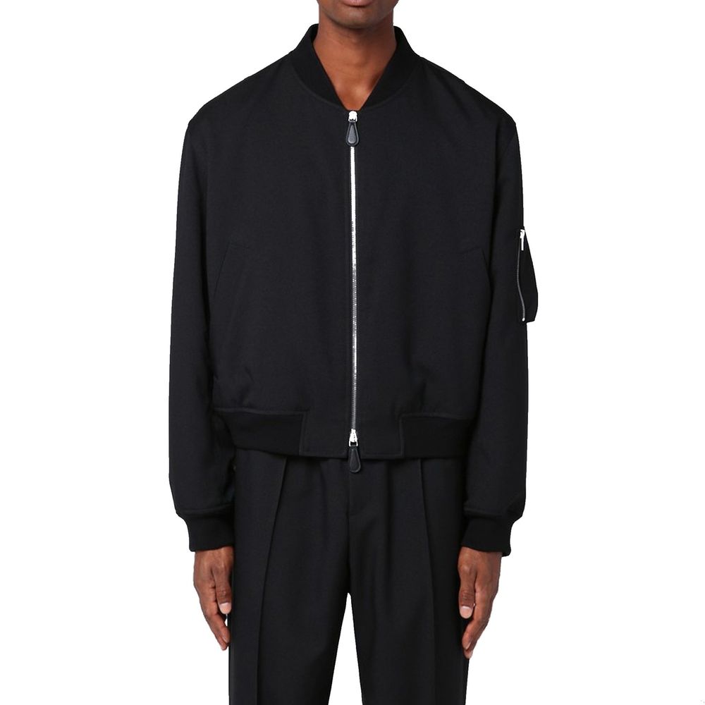 Elevate your wardrobe with the Jil Sander Black Polyester Bomber, a masterpiece of Italian craftsmanship that exudes sophistication and timeless elegance.