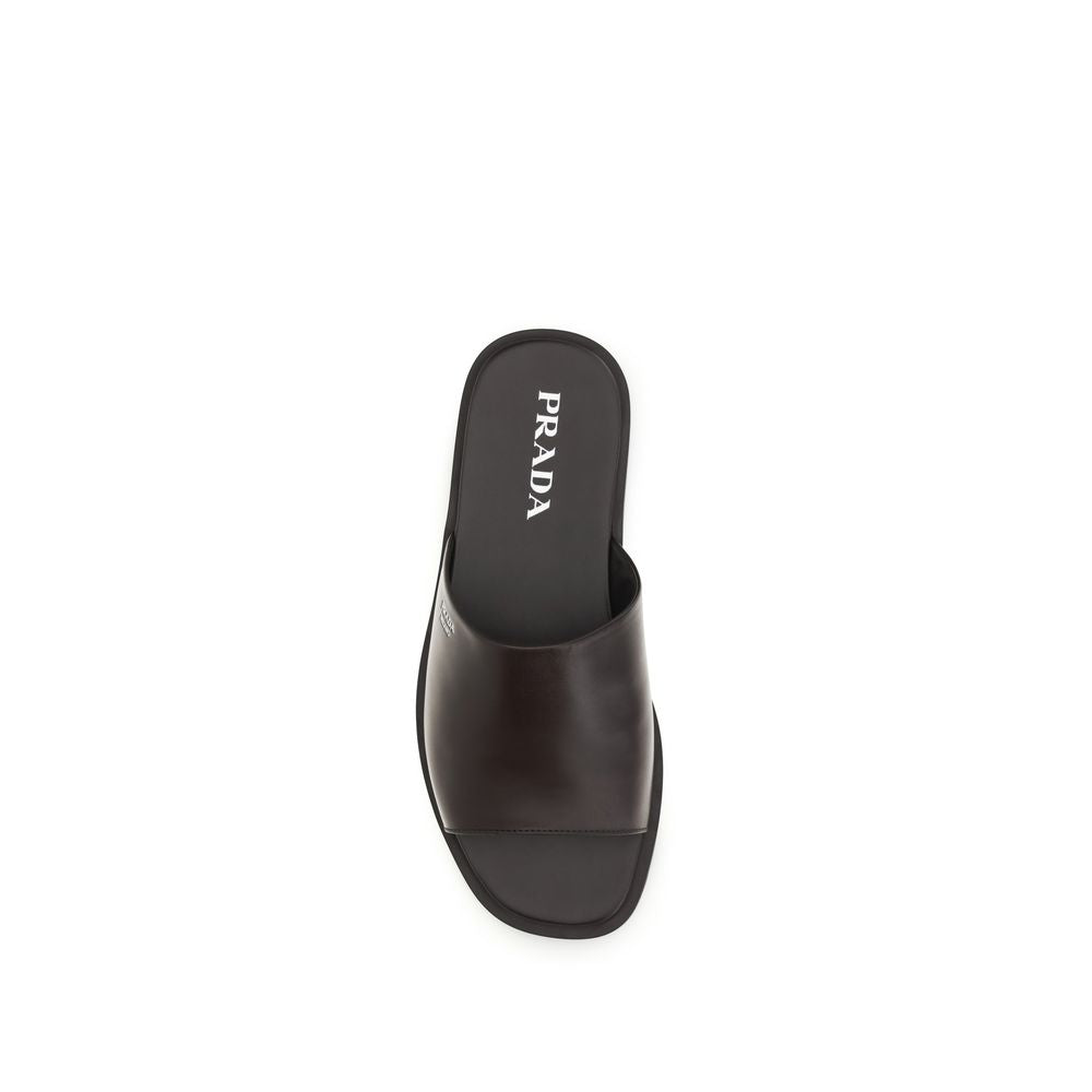 Step into the realm of sophistication with Prada's Brown Calf Leather Bos Taurus Flip-Flop Sandals, where exquisite craftsmanship meets luxurious comfort for the discerning individual.