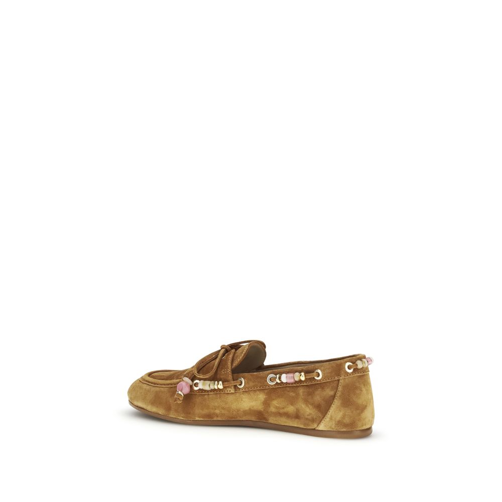 Indulge in the exquisite Stuart Weitzman Brown Calf Leather Bos Taurus Slip-On Loafers, where Italian craftsmanship meets timeless elegance for the discerning fashion connoisseur.