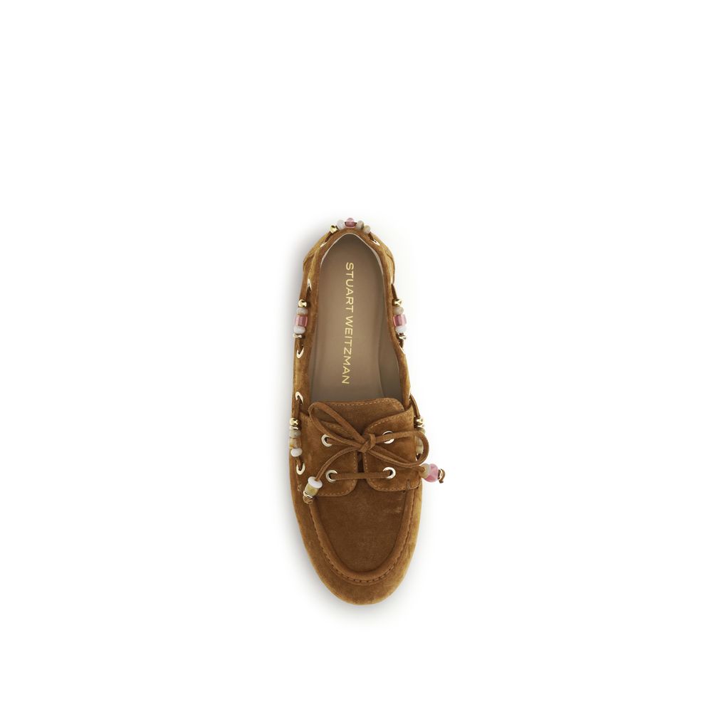 Indulge in the exquisite Stuart Weitzman Brown Calf Leather Bos Taurus Slip-On Loafers, where unparalleled craftsmanship meets timeless elegance, perfect for the discerning fashion connoisseur.