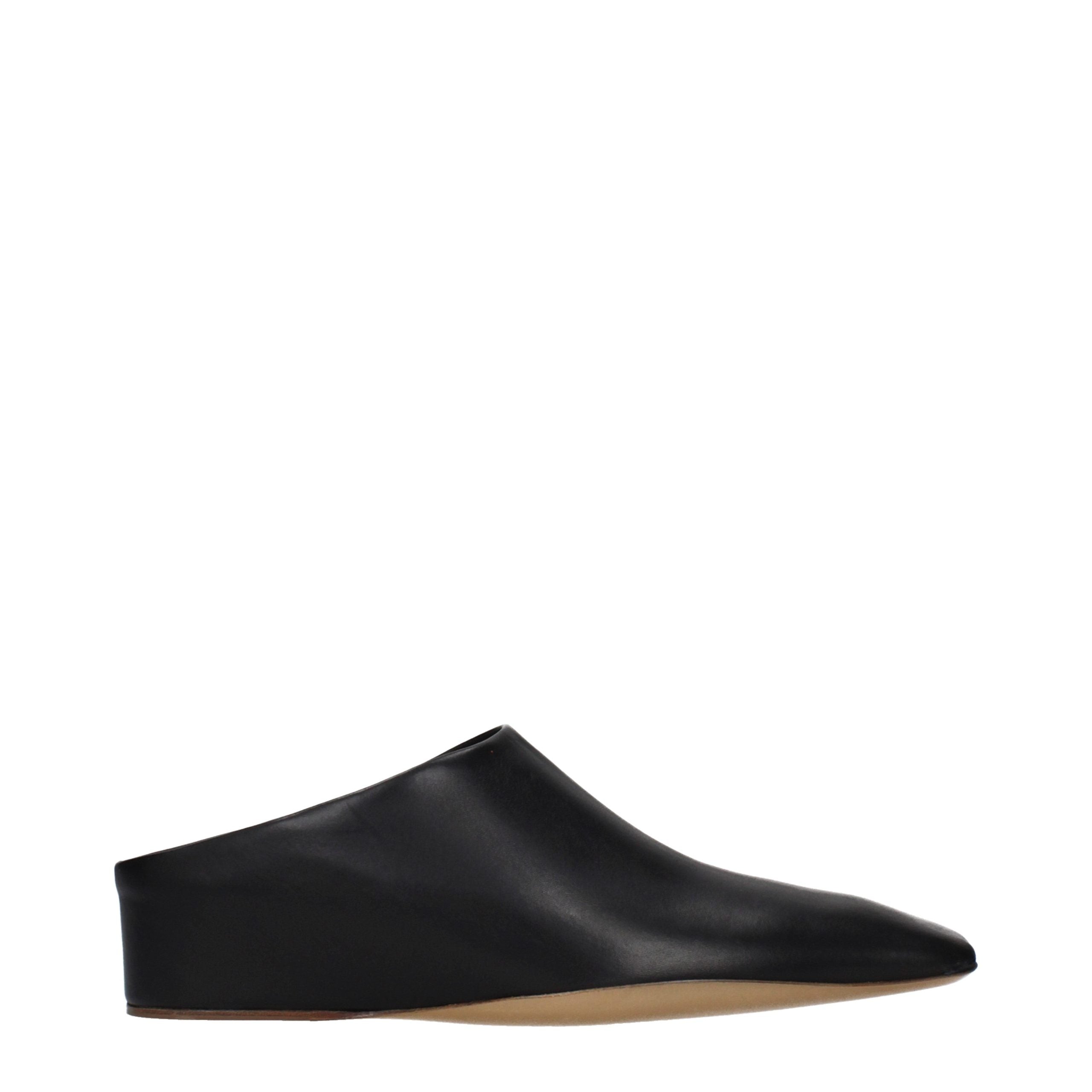 Experience the allure of Jil Sander Black Leather Slippers, where exquisite craftsmanship meets timeless elegance, perfect for those who embody sophistication and style.