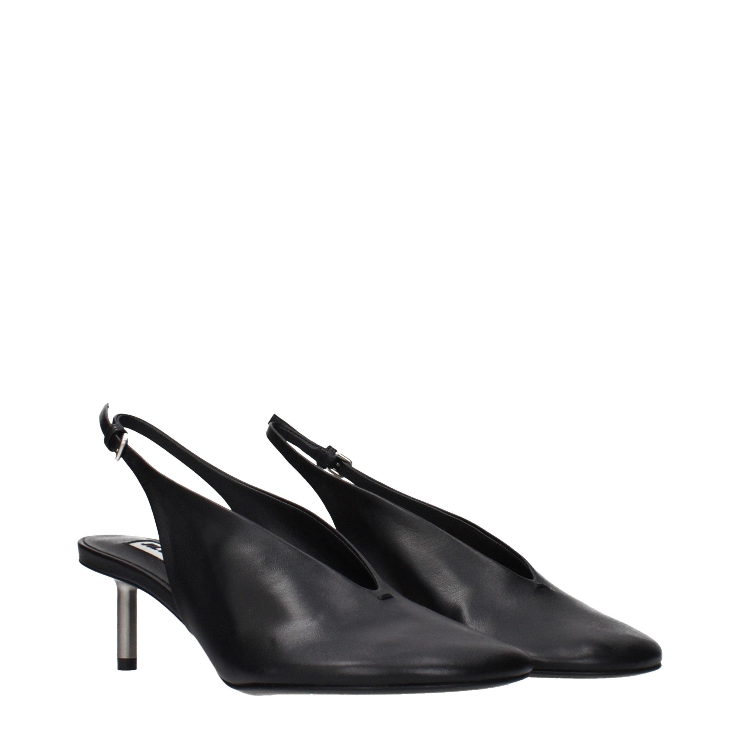 Discover the Jil Sander Black Leather Pumps, where vintage elegance meets modern sophistication, perfect for those who command attention and exude luxury.