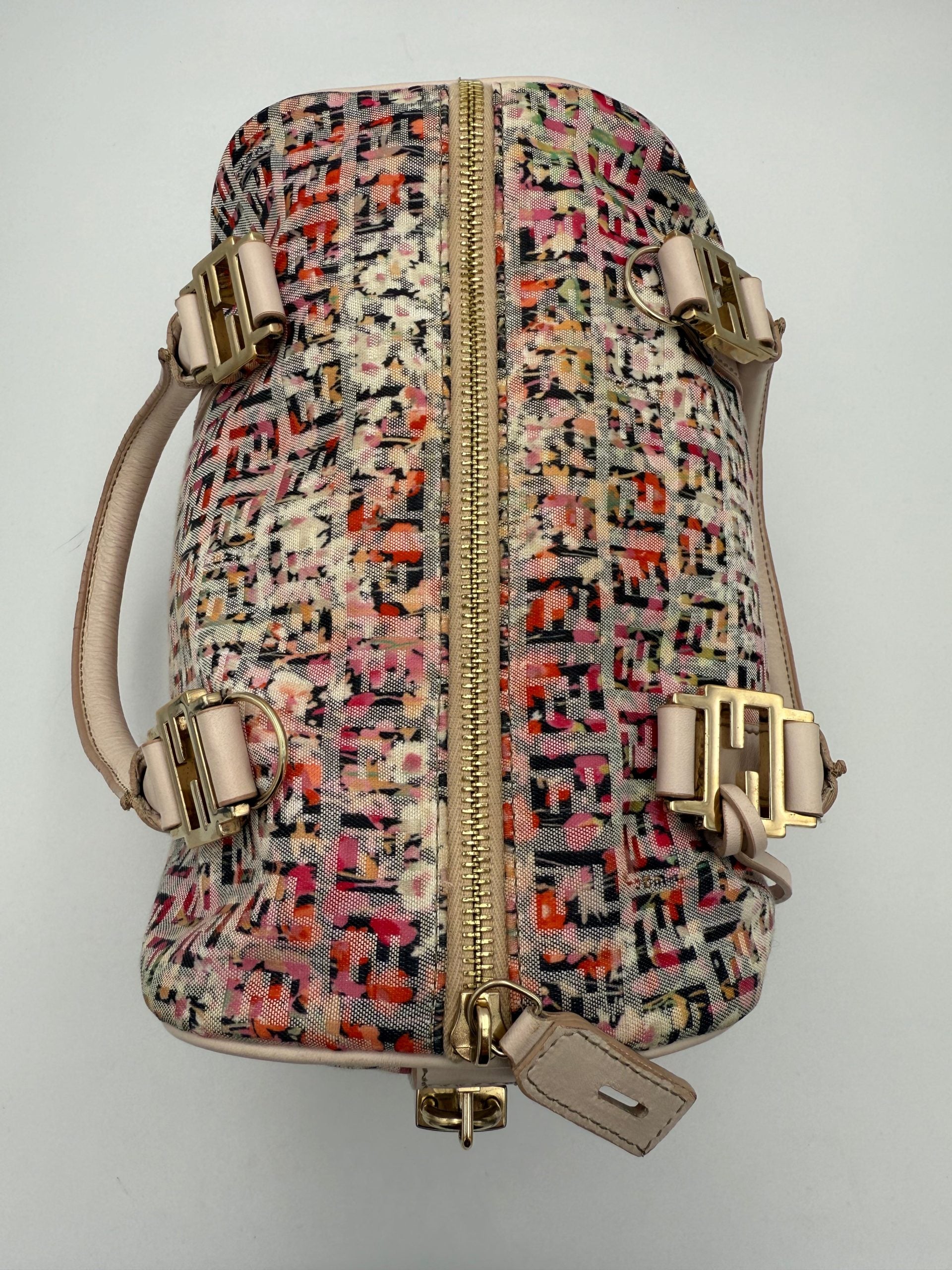 Elevate your style with the Fendi FENDI FF Canvas Fiori Handbag, a luxurious blend of floral elegance and expert Italian craftsmanship, perfect for any occasion.
