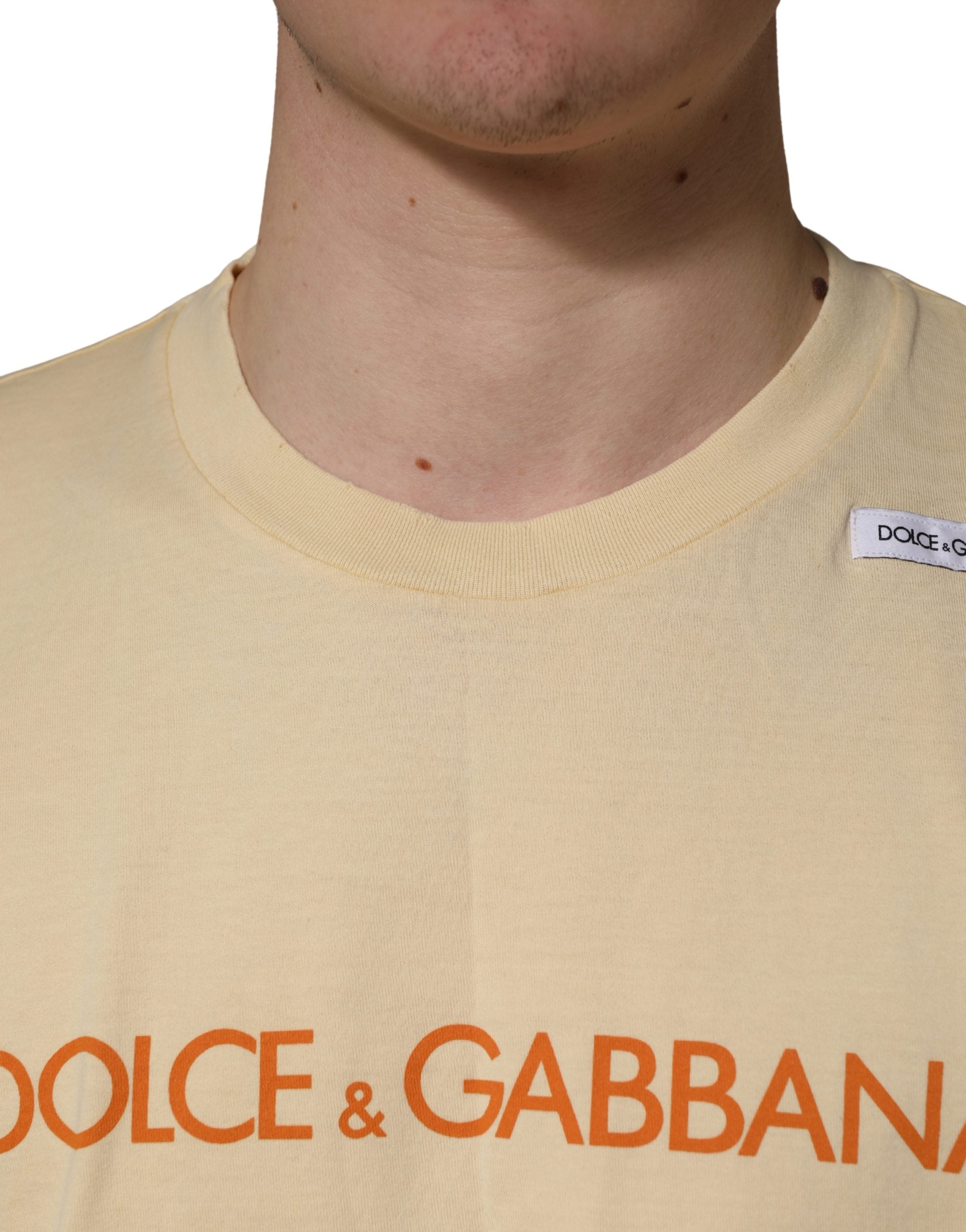 Discover the allure of Dolce & Gabbana's Yellow Logo Print Cotton Crew Neck T-shirt, a testament to Italian craftsmanship that elevates your wardrobe with effortless elegance.