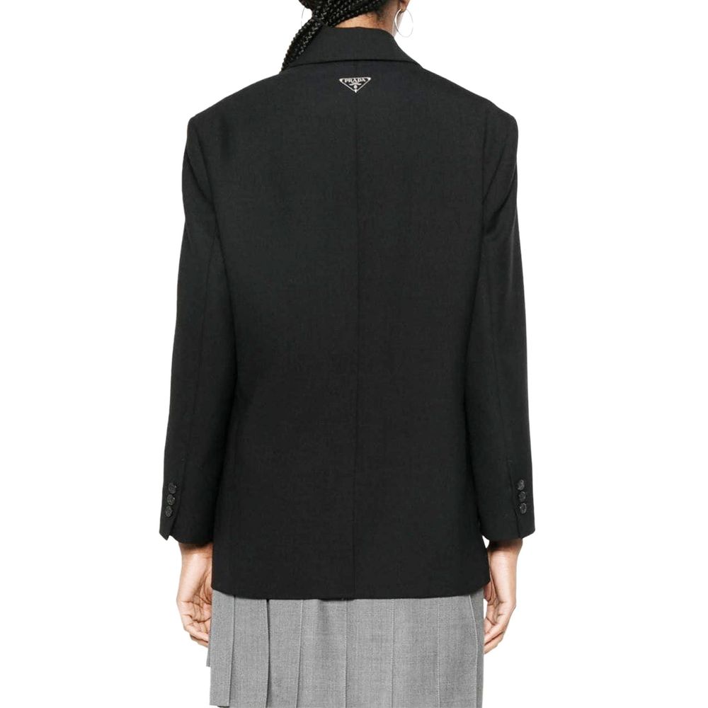 Discover the Prada Black Virgin Wool Blazer, a masterpiece of Italian craftsmanship, exuding timeless elegance and sophistication for the discerning individual.