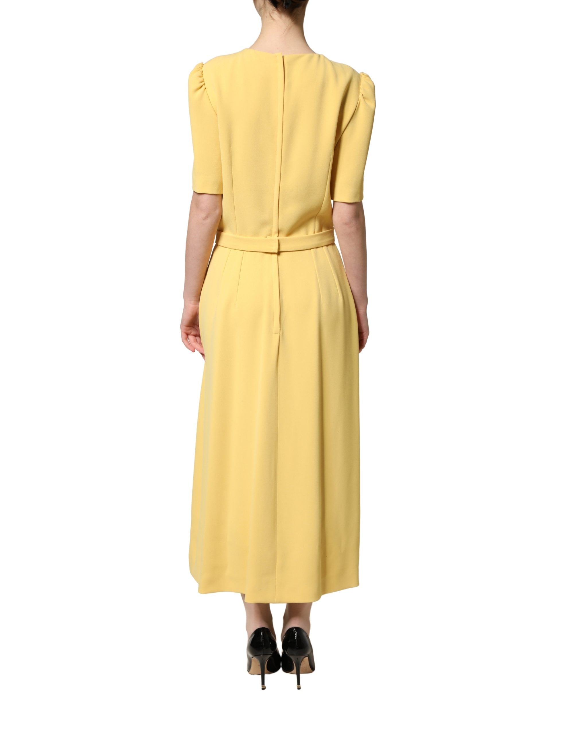Discover the exquisite Dolce & Gabbana Yellow Short-Sleeved Crew Neck Midi Dress, a luxurious blend of silk and viscose, embodying Italian craftsmanship and timeless elegance.