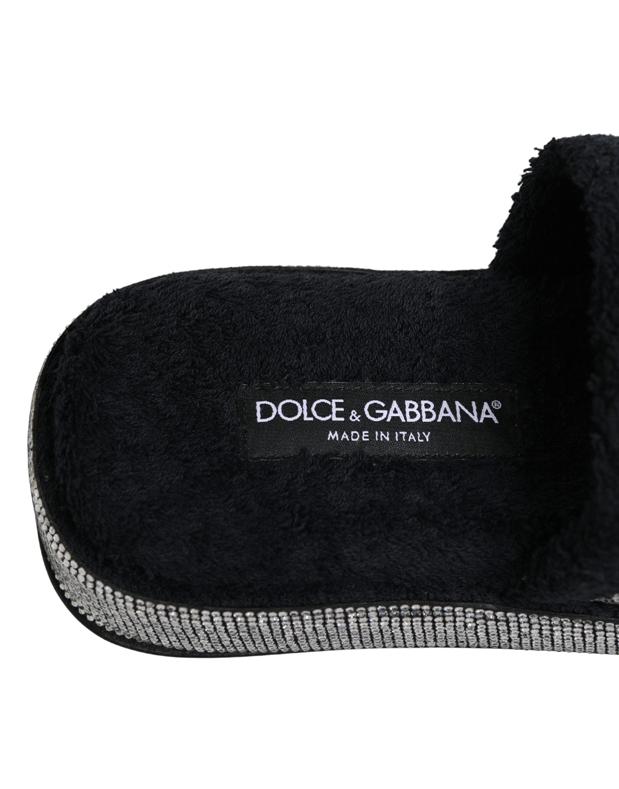 Experience the allure of Dolce & Gabbana's black crystal-embellished platform slides, where exquisite craftsmanship and luxurious comfort elevate your style to new heights.