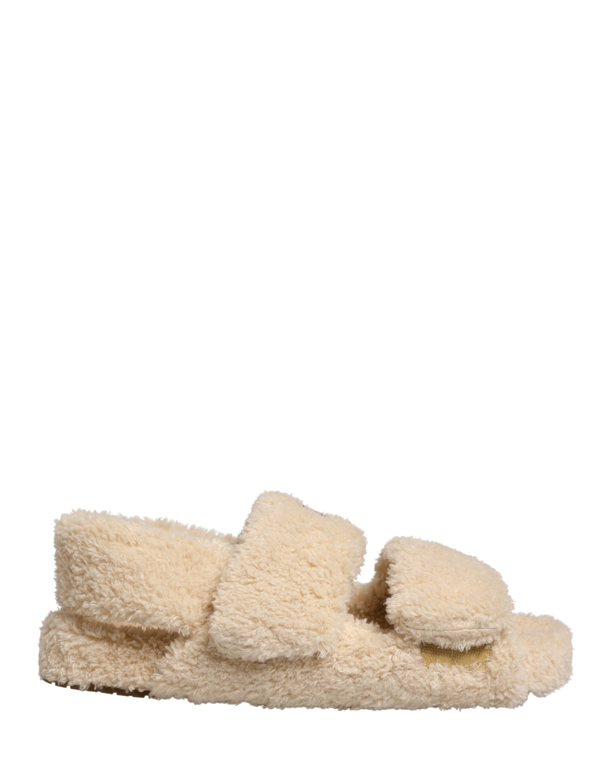 Elevate your casual elegance with Dolce & Gabbana's beige faux fur slides, where sumptuous comfort meets high-fashion allure, perfect for discerning tastes.