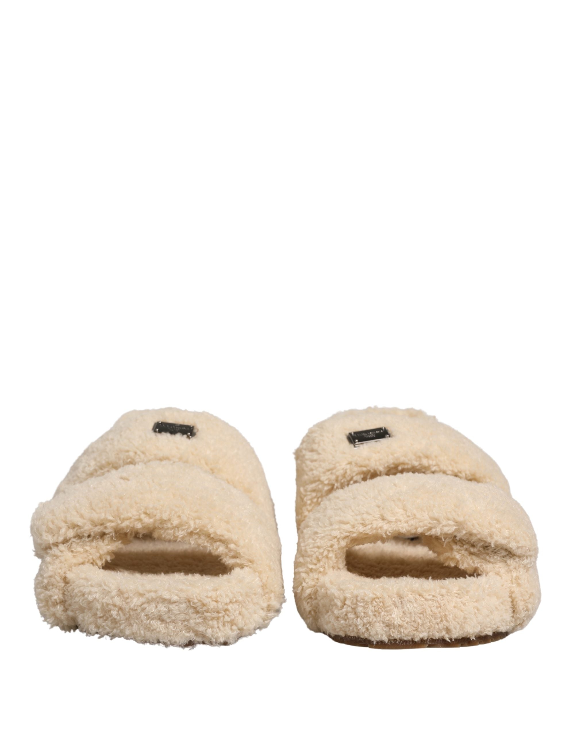 Elevate your style with Dolce & Gabbana's Beige Faux Fur Slides, where sumptuous comfort meets high-fashion elegance, perfect for any discerning wardrobe.