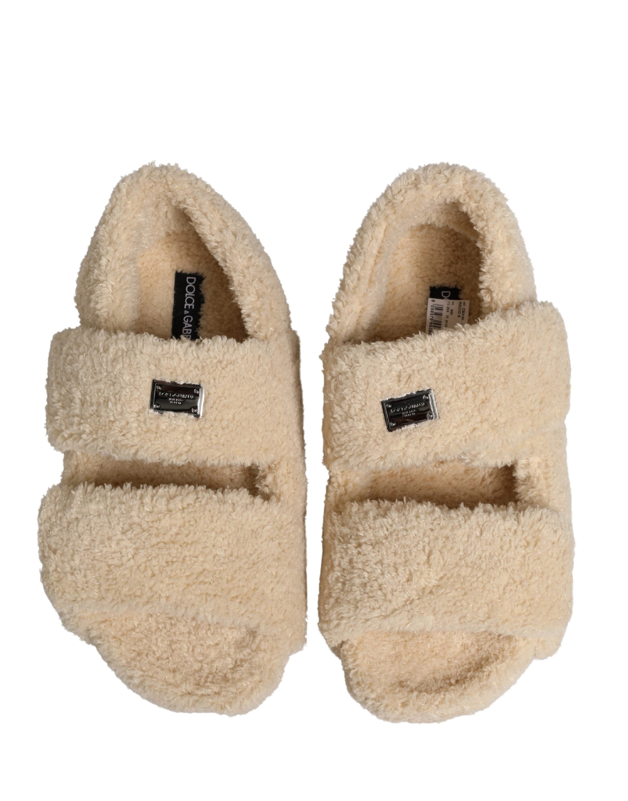 Elevate your style with Dolce & Gabbana's Beige Faux Fur Slides, a luxurious blend of comfort and high-fashion elegance, perfect for the discerning individual.