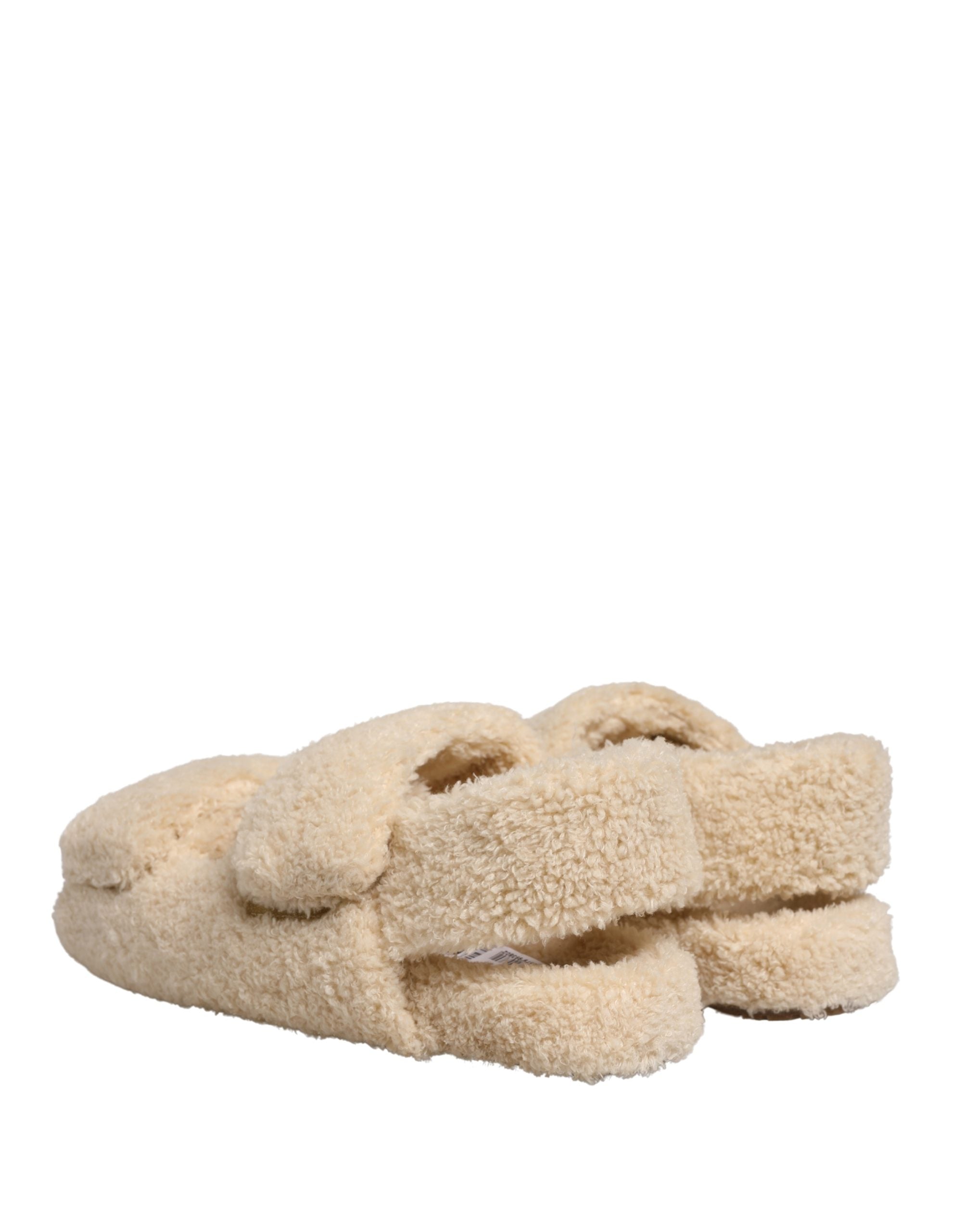 Elevate your style with Dolce & Gabbana's Beige Faux Fur Slides, where sumptuous comfort meets high-fashion elegance, perfect for the discerning individual.
