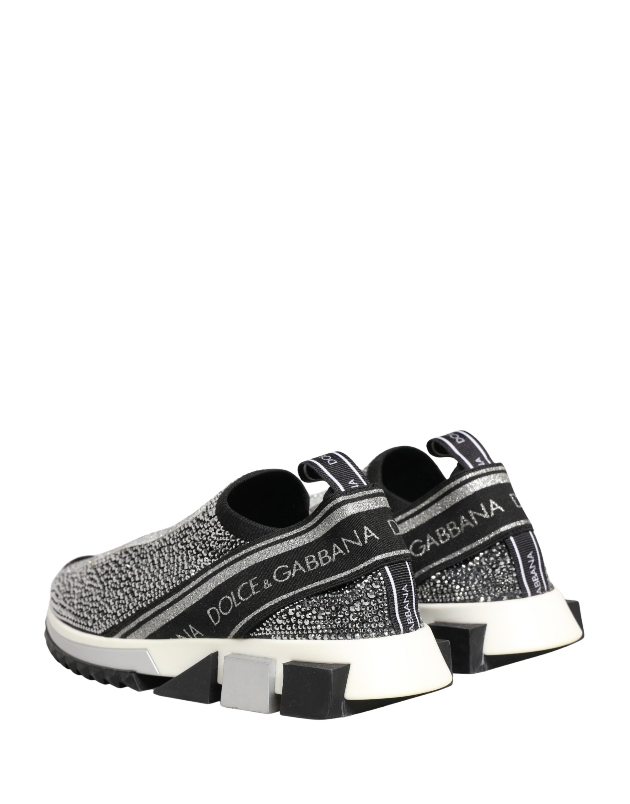Elevate your style with Dolce & Gabbana's Silver Crystal Logo Slip On Sorrento Sneakers, where Italian craftsmanship meets luxurious comfort in a striking black and silver design.