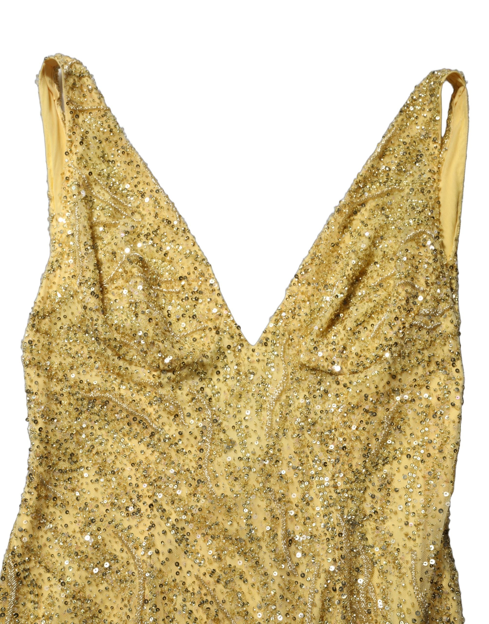 Indulge in the exquisite allure of the Dolce & Gabbana Gold V-neckline Mermaid Sequinned Gown, a masterpiece of luxury and craftsmanship, perfect for unforgettable evenings.