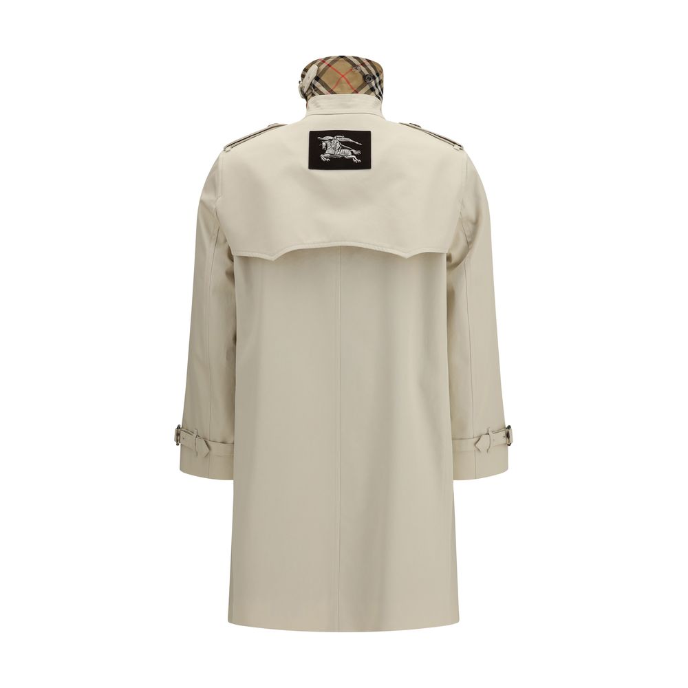 Elevate your wardrobe with the Burberry Beige Cotton Trench Coat, a masterpiece of rain-resistant gabardine, embodying timeless elegance and sophisticated allure.