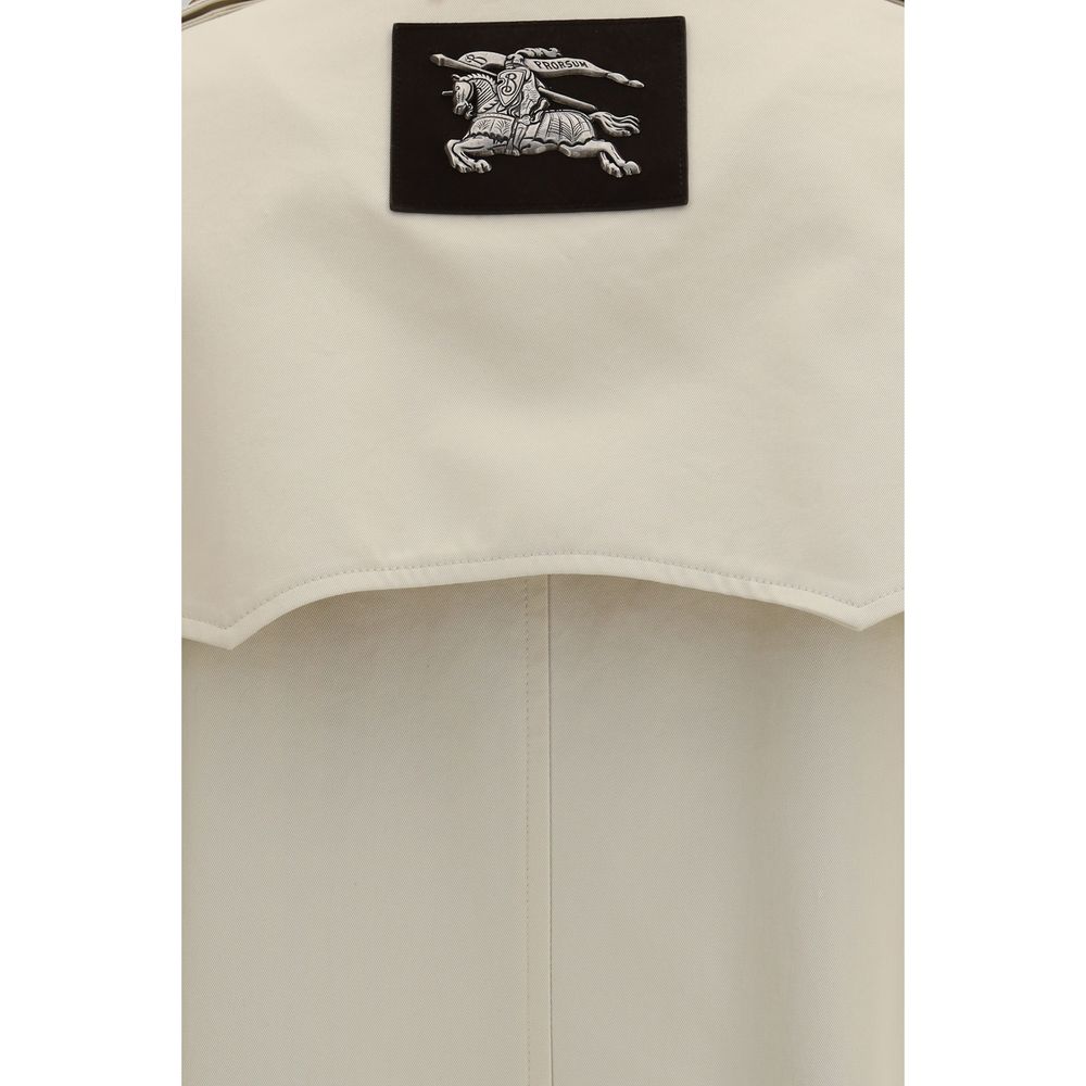 Elevate your wardrobe with the Burberry Beige Cotton Trench Coat, a masterpiece of rain-resistant gabardine that embodies timeless elegance and sophisticated allure.