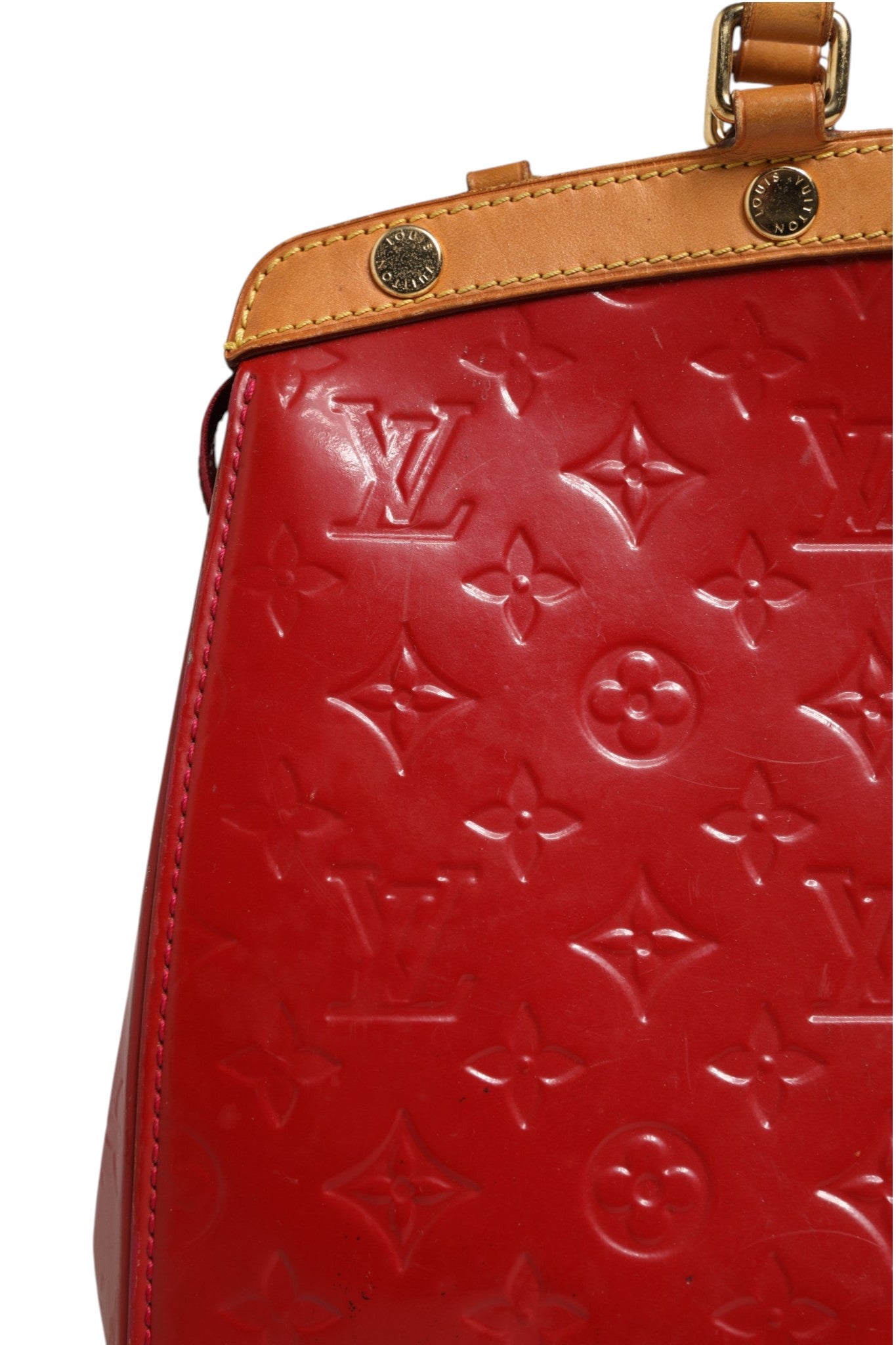 Indulge in the elegance of the Louis Vuitton Brea MM Monogram Vernis, a luxurious red handbag that embodies sophistication and timeless allure, perfect for any occasion.