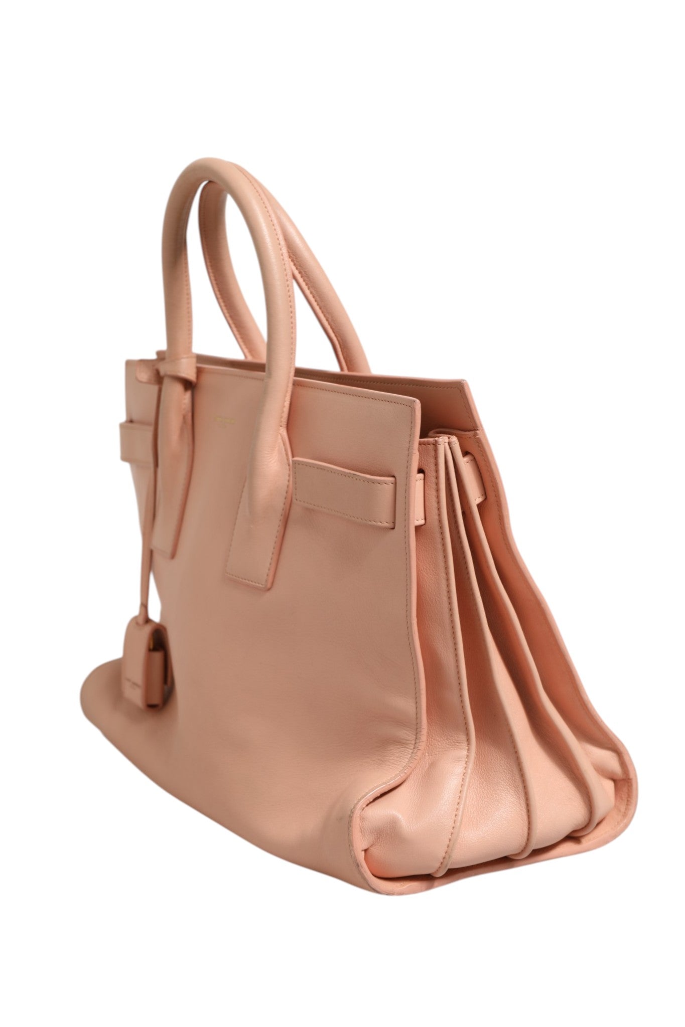 Experience the allure of the Saint Laurent Nano Sac De Jour, a masterpiece of craftsmanship in pink, embodying timeless elegance and sophisticated style for the discerning individual.
