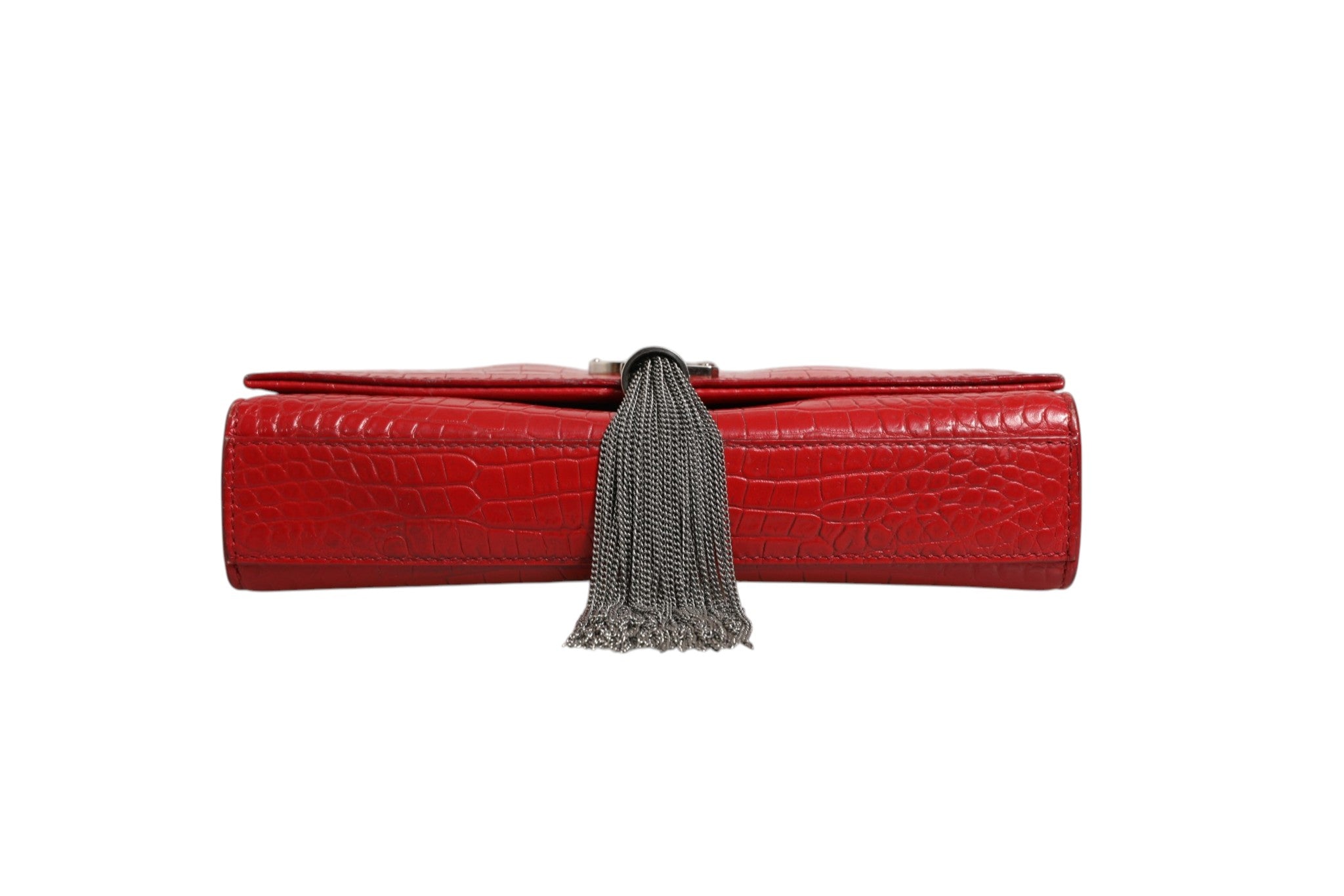 Indulge in the allure of the Saint Laurent Kate Tassel Chain Bag, crafted from sumptuous red crocodile embossed leather, a timeless statement of elegance and sophistication.