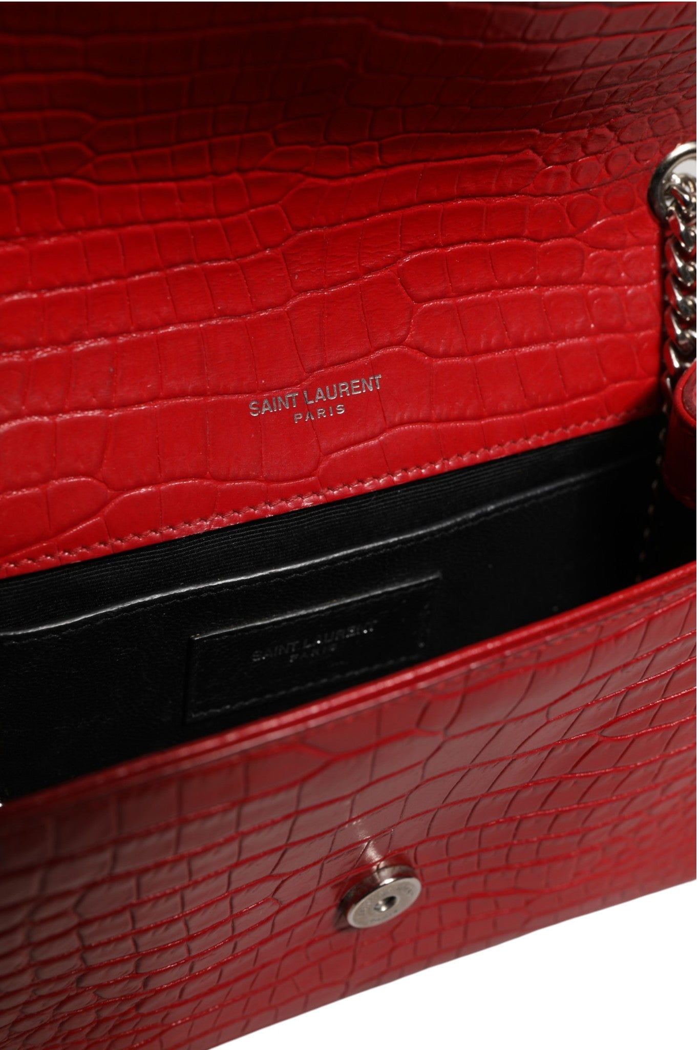 Indulge in the allure of the Saint Laurent Kate Tassel Chain Bag, crafted from sumptuous red crocodile embossed leather, a timeless symbol of luxury and sophistication.