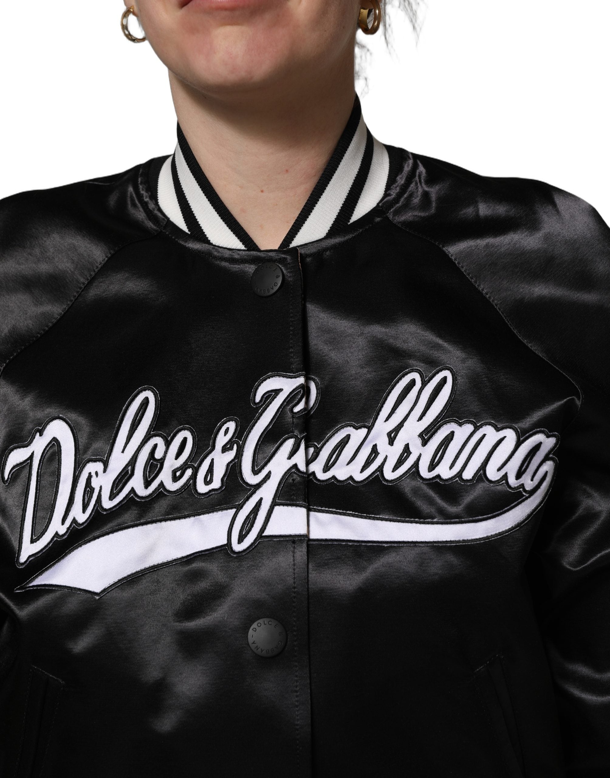 Discover the Dolce & Gabbana Black Satin Floral Embroidery Bomber Jacket, a masterpiece of Italian craftsmanship blending sporty elegance with timeless luxury for any occasion.