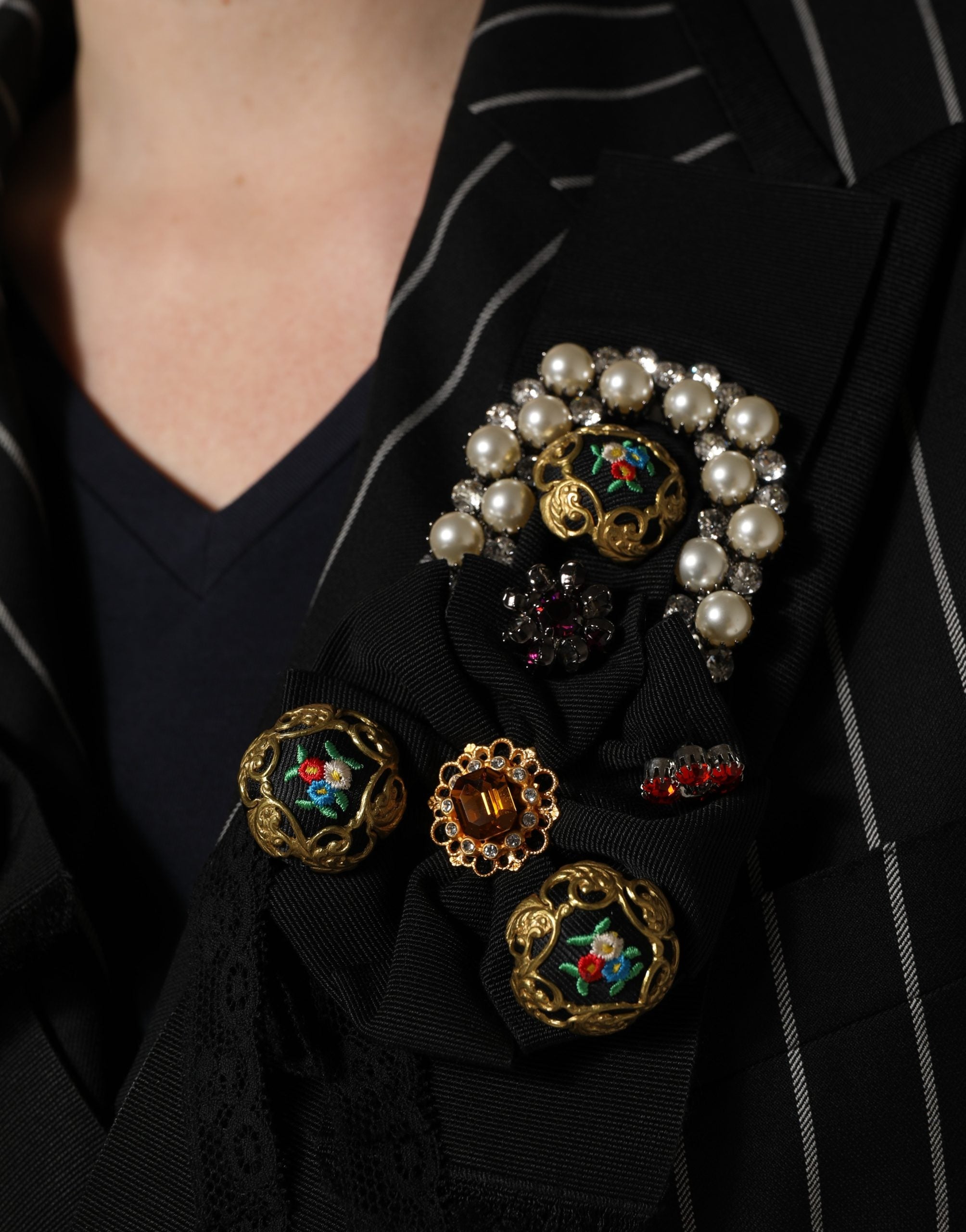 Elevate your wardrobe with the Dolce & Gabbana Black Stripe Double-Breasted Blazer, a masterpiece of luxurious wool and floral appliqué, embodying timeless sophistication.