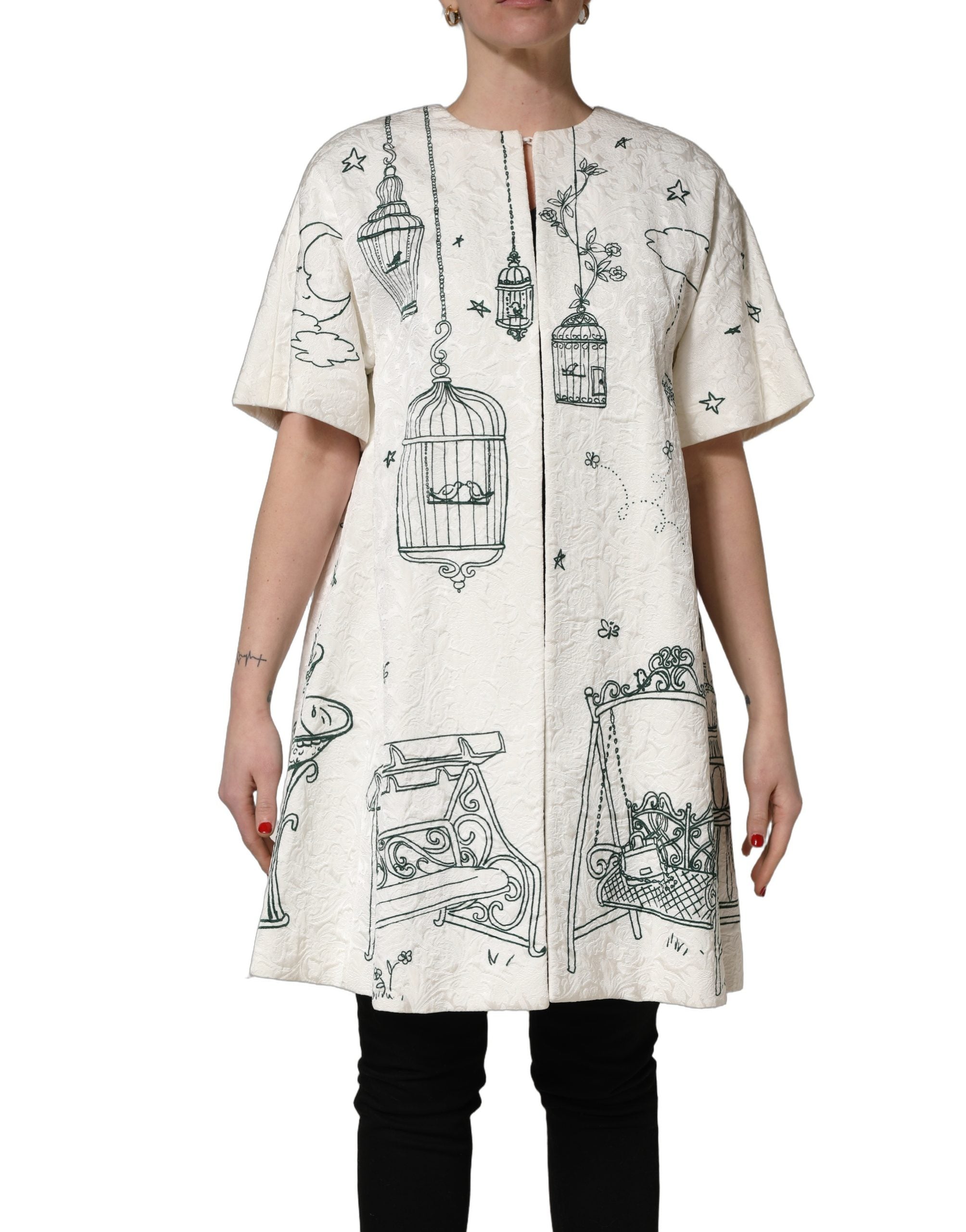 Indulge in the exquisite Dolce & Gabbana White Jacquard Garden Print Coat, a luxurious blend of silk and cotton, celebrating Italian artistry and timeless elegance.