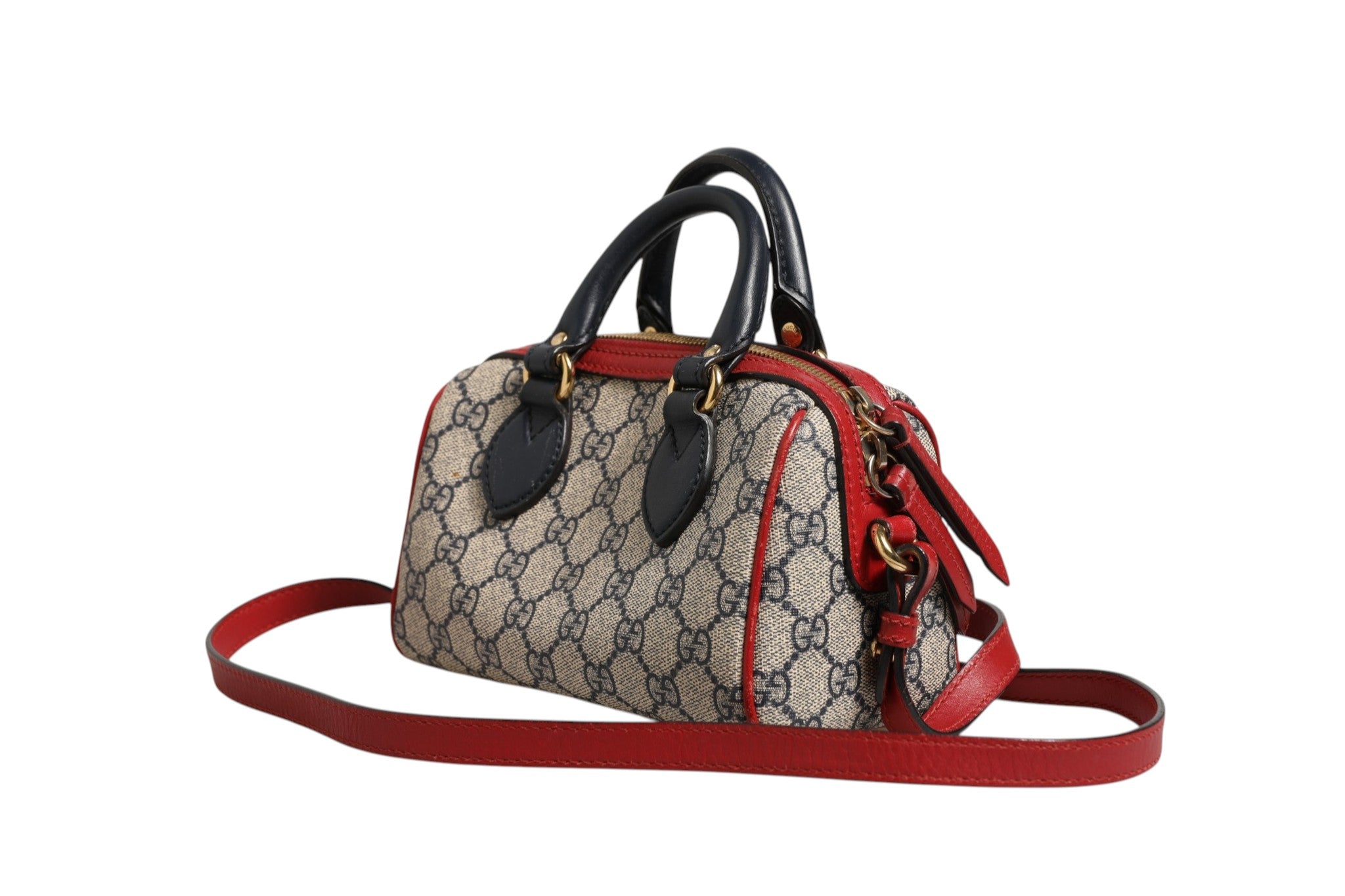 Discover the Gucci GG Supreme Mini Boston Bag, a timeless blend of red and blue elegance, showcasing exquisite craftsmanship and luxurious appeal for the discerning individual.