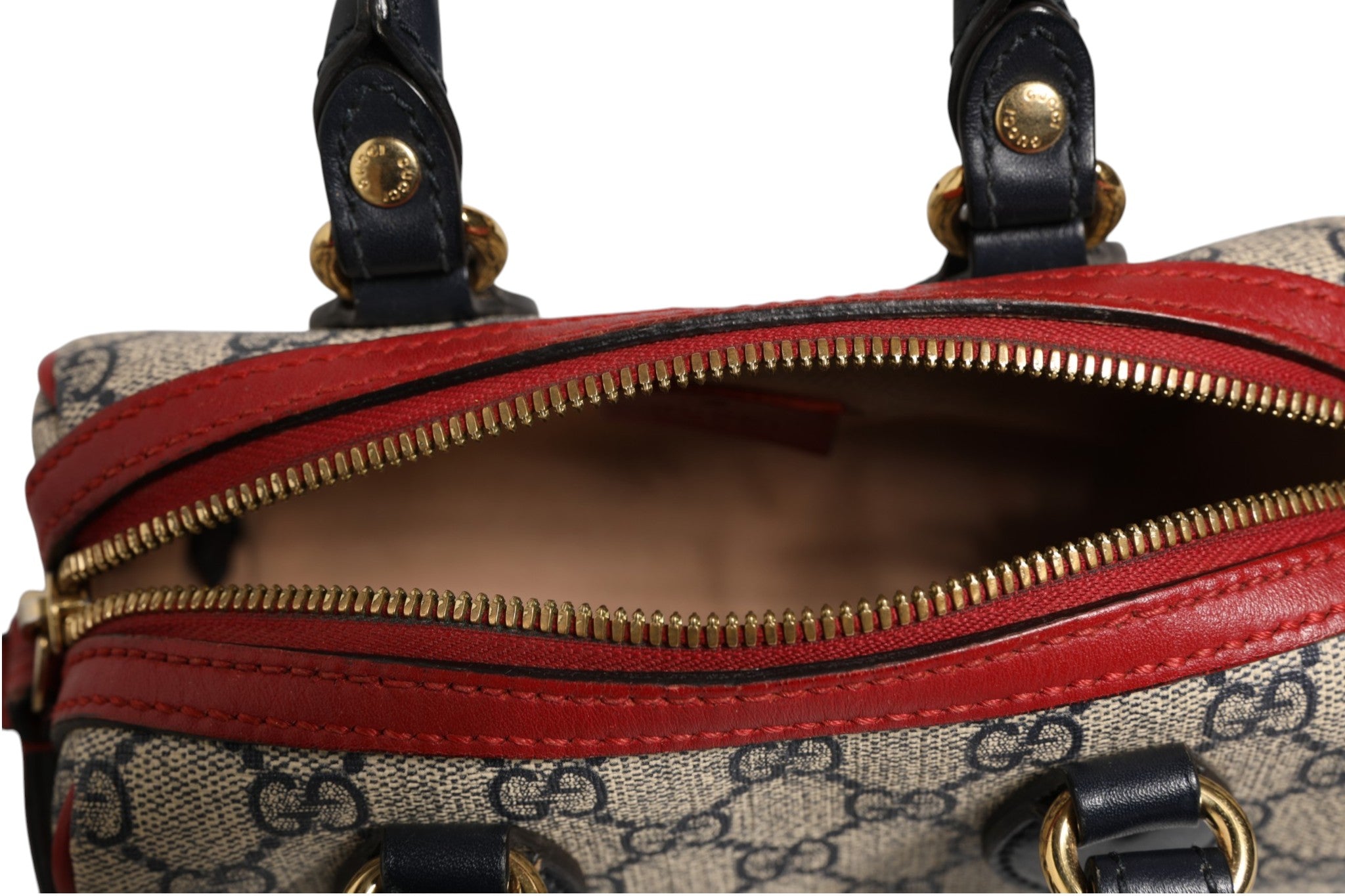 Discover the Gucci GG Supreme Mini Boston Bag, a luxurious blend of red and blue elegance, showcasing exquisite craftsmanship and timeless allure for the discerning individual.