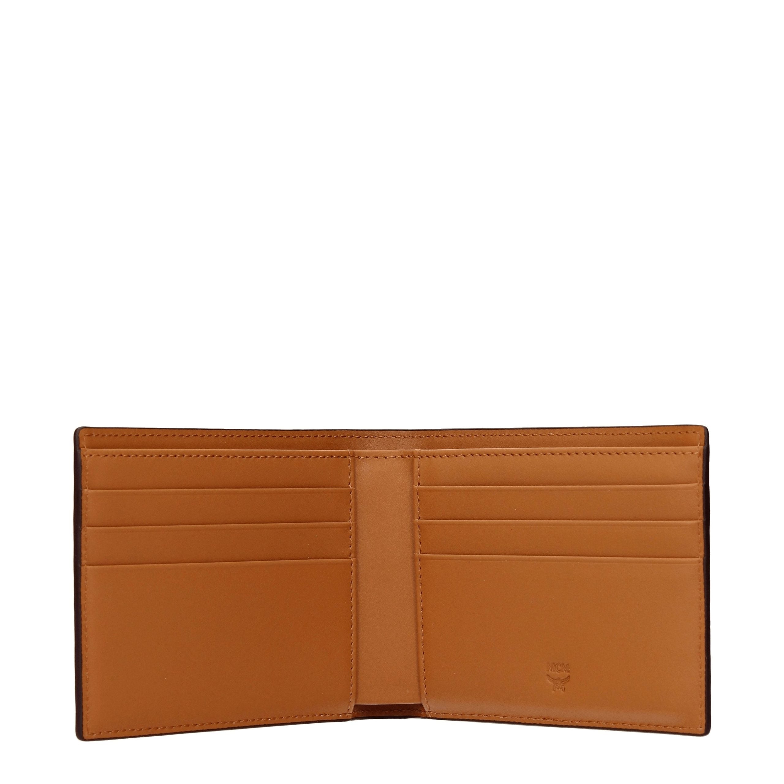 Experience the exquisite MCM Brown Fabric Wallet, a luxurious leather accessory that embodies sophistication and timeless elegance for the discerning individual.