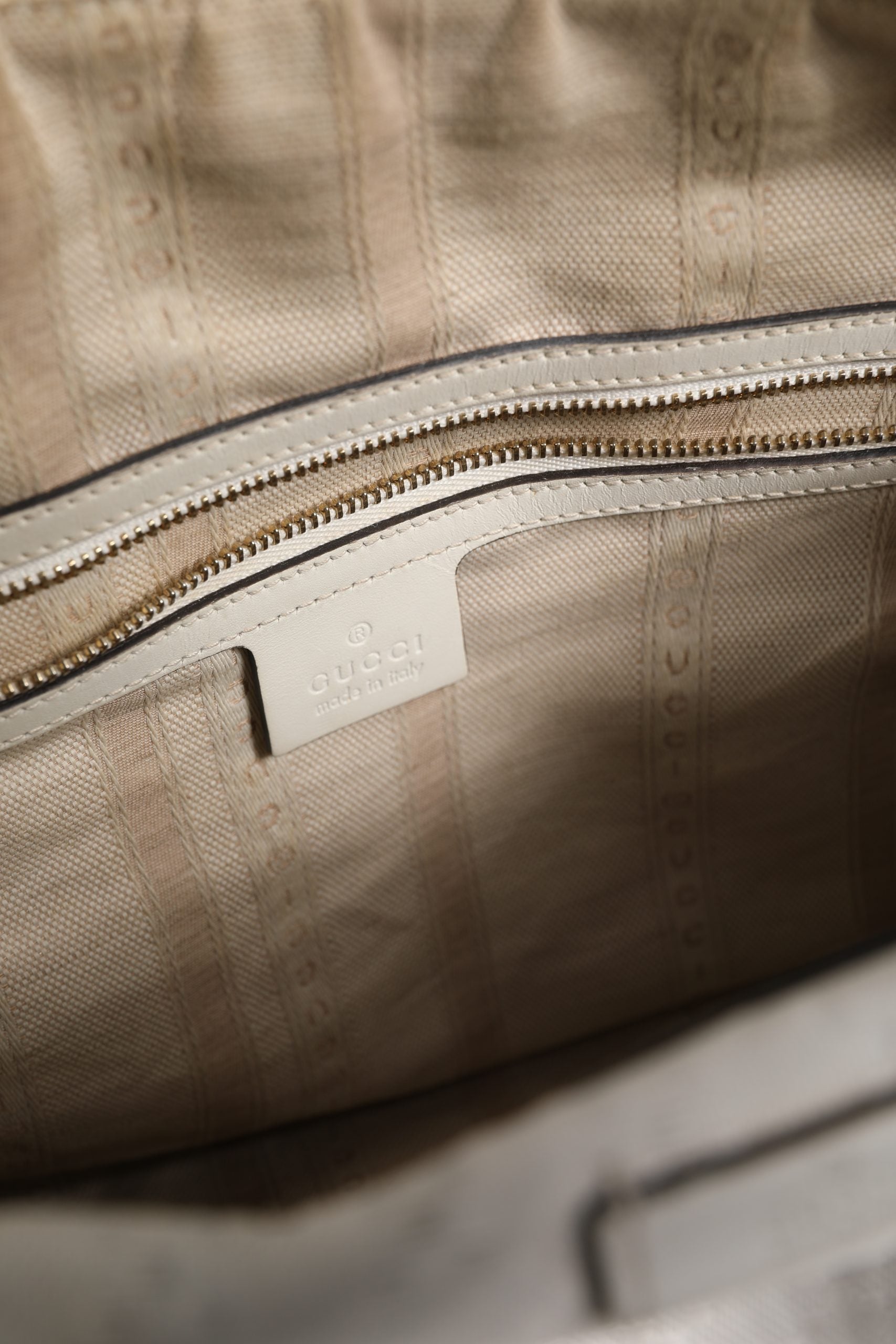Elevate your style with the Gucci Medium Diamante Leather Boston Bag, a timeless blend of exquisite craftsmanship and luxurious design, perfect for any occasion.