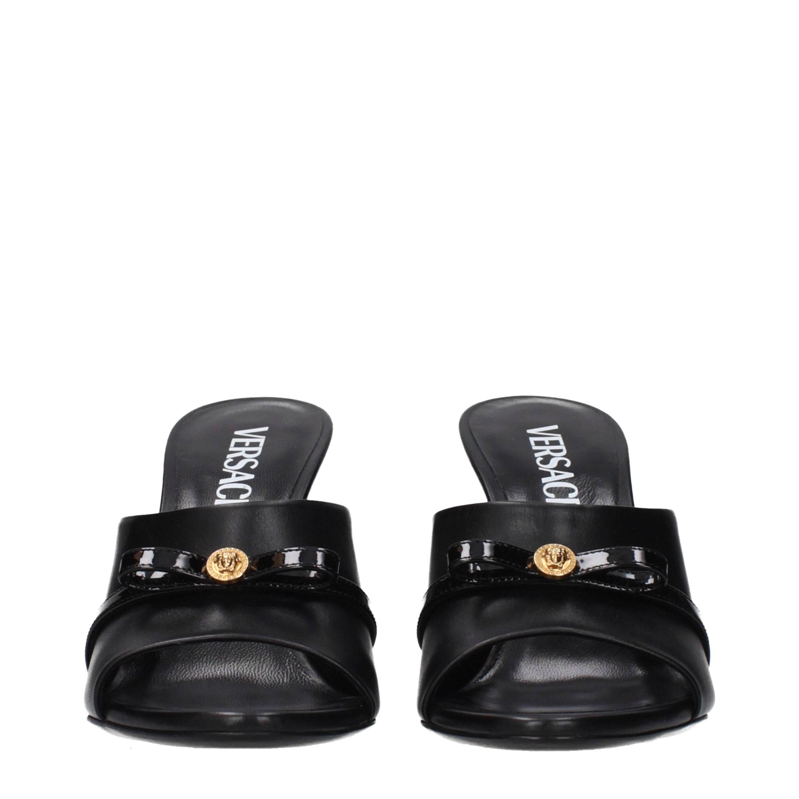 Elevate your elegance with Versace Black Leather Wedge Sandals, where exquisite craftsmanship meets timeless luxury, perfect for the discerning individual.
