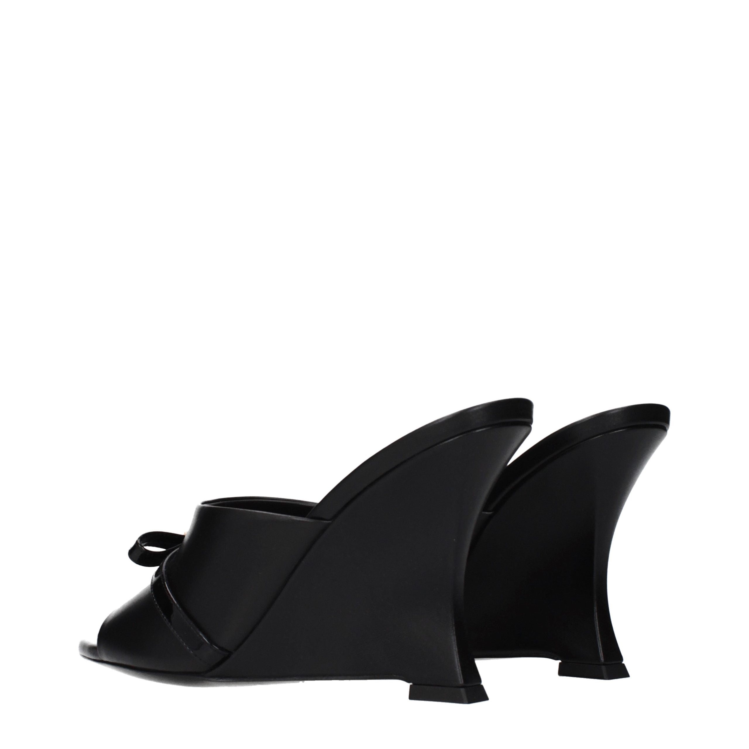 Step into the realm of luxury with Versace Black Leather Wedge Sandals, where exquisite craftsmanship meets timeless elegance, perfect for any discerning wardrobe.