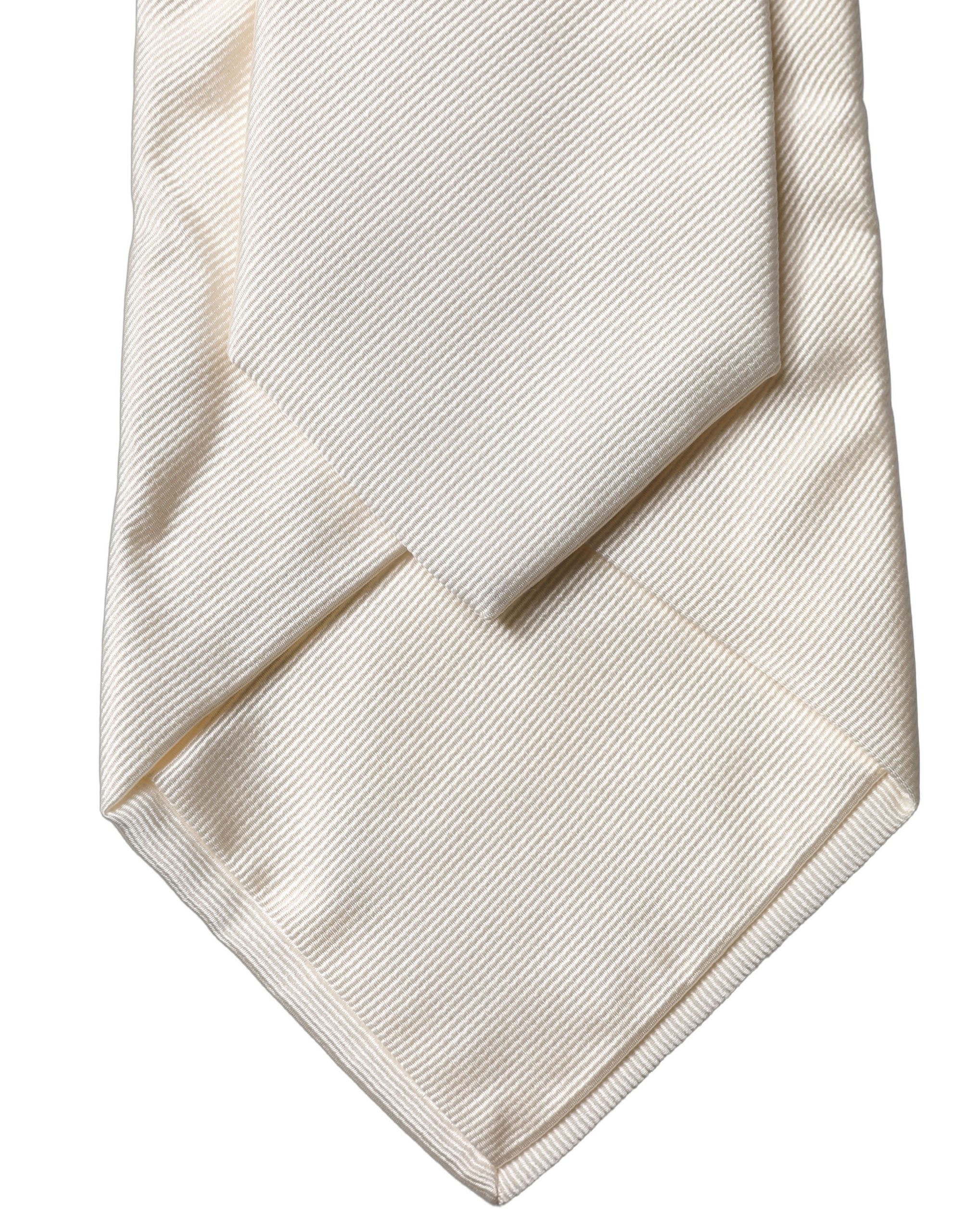 Elevate your style with the Dolce & Gabbana Off White Solid Silk Adjustable Necktie, a symbol of Italian elegance and luxurious craftsmanship for the discerning individual.