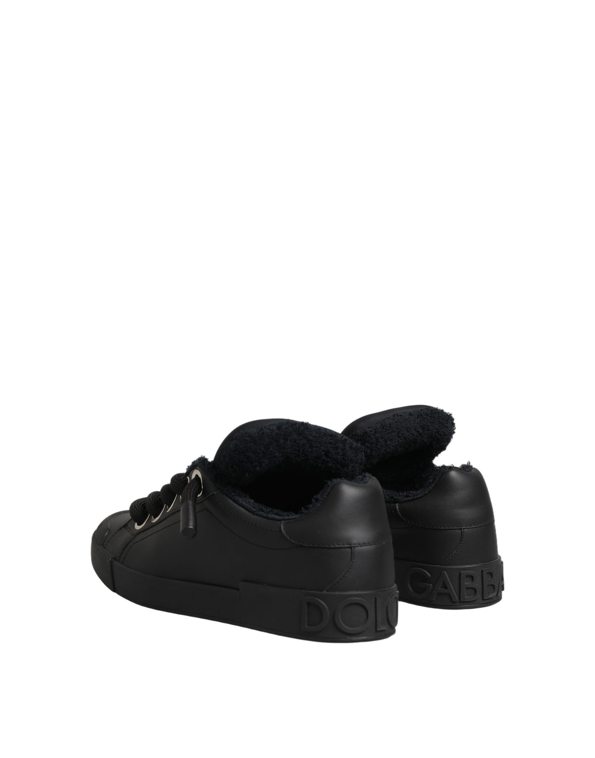 Elevate your style with Dolce & Gabbana's Black Leather Low Top Portofino Sneakers, where artisanal craftsmanship meets luxurious comfort for the discerning individual.