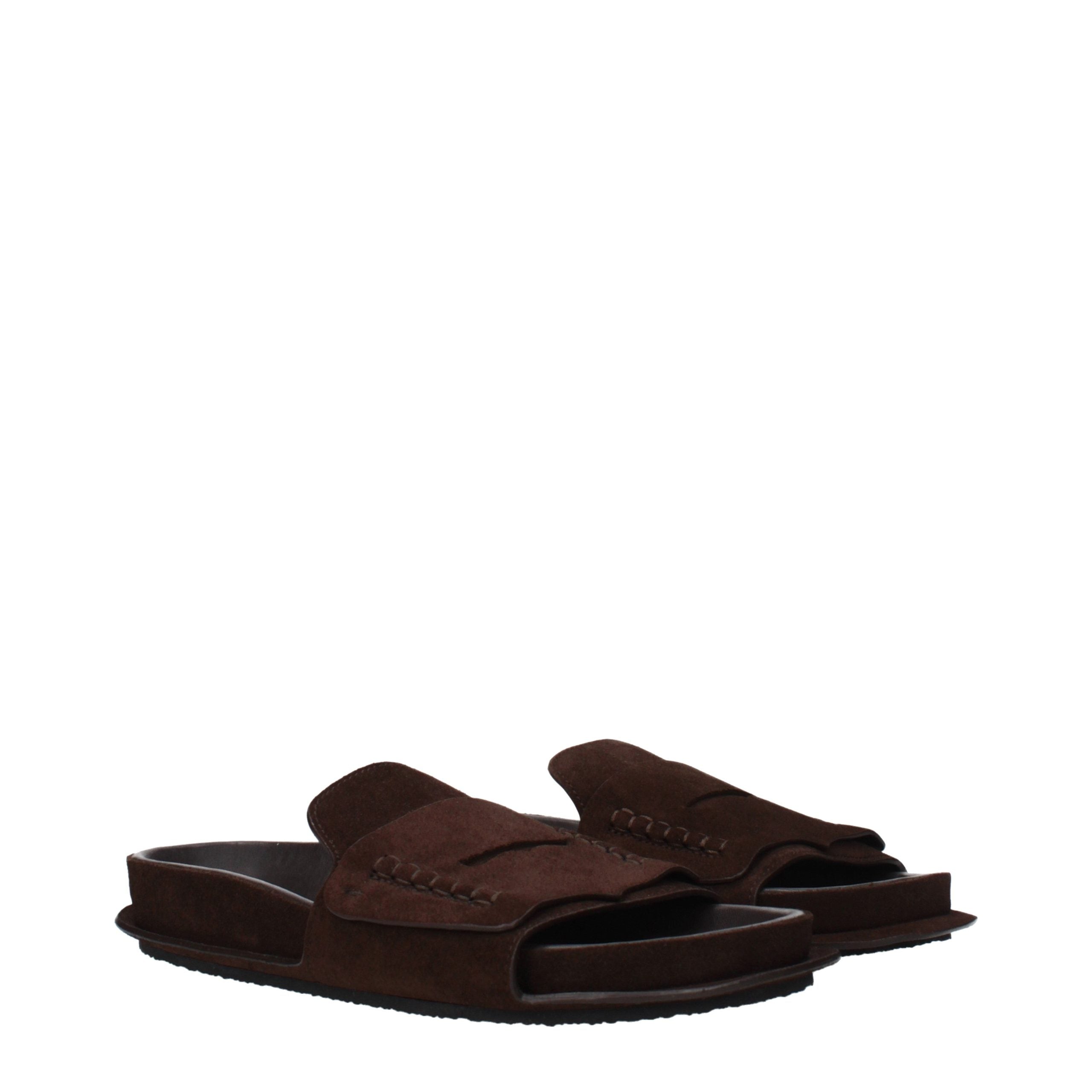 Indulge in the exquisite craftsmanship of Jacquemus Brown Leather Slippers, where luxurious suede meets timeless elegance, perfect for the discerning fashion connoisseur.