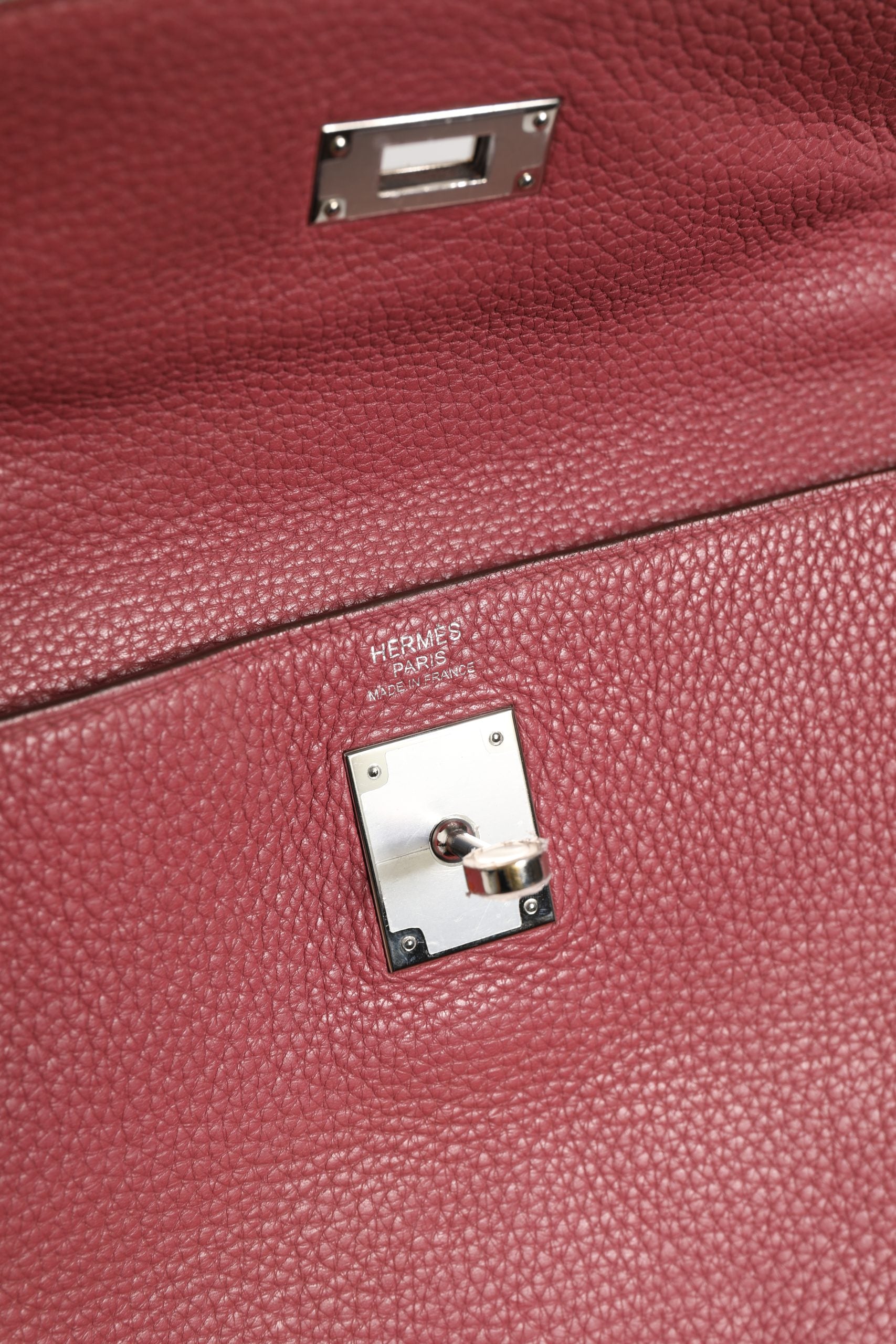 Discover the Hermès Kelly 32 in Rouge H Togo, a masterpiece of luxury craftsmanship that embodies timeless elegance and sophistication for discerning connoisseurs.