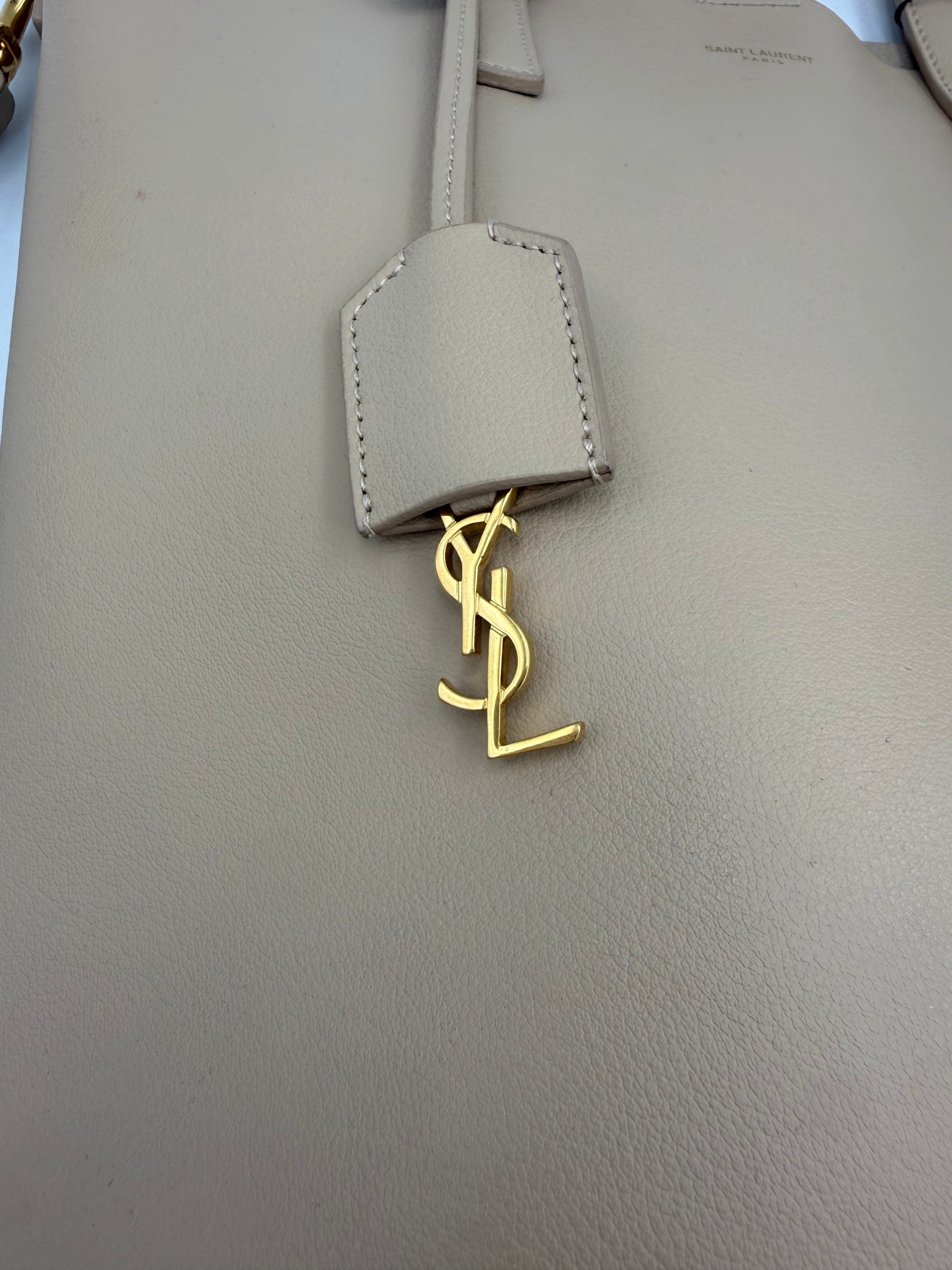 Elevate your style with the Saint Laurent SAINT LAURENT SHOPPING Beige Bag, a masterpiece of fine calf leather and golden accents, embodying timeless luxury and sophistication.