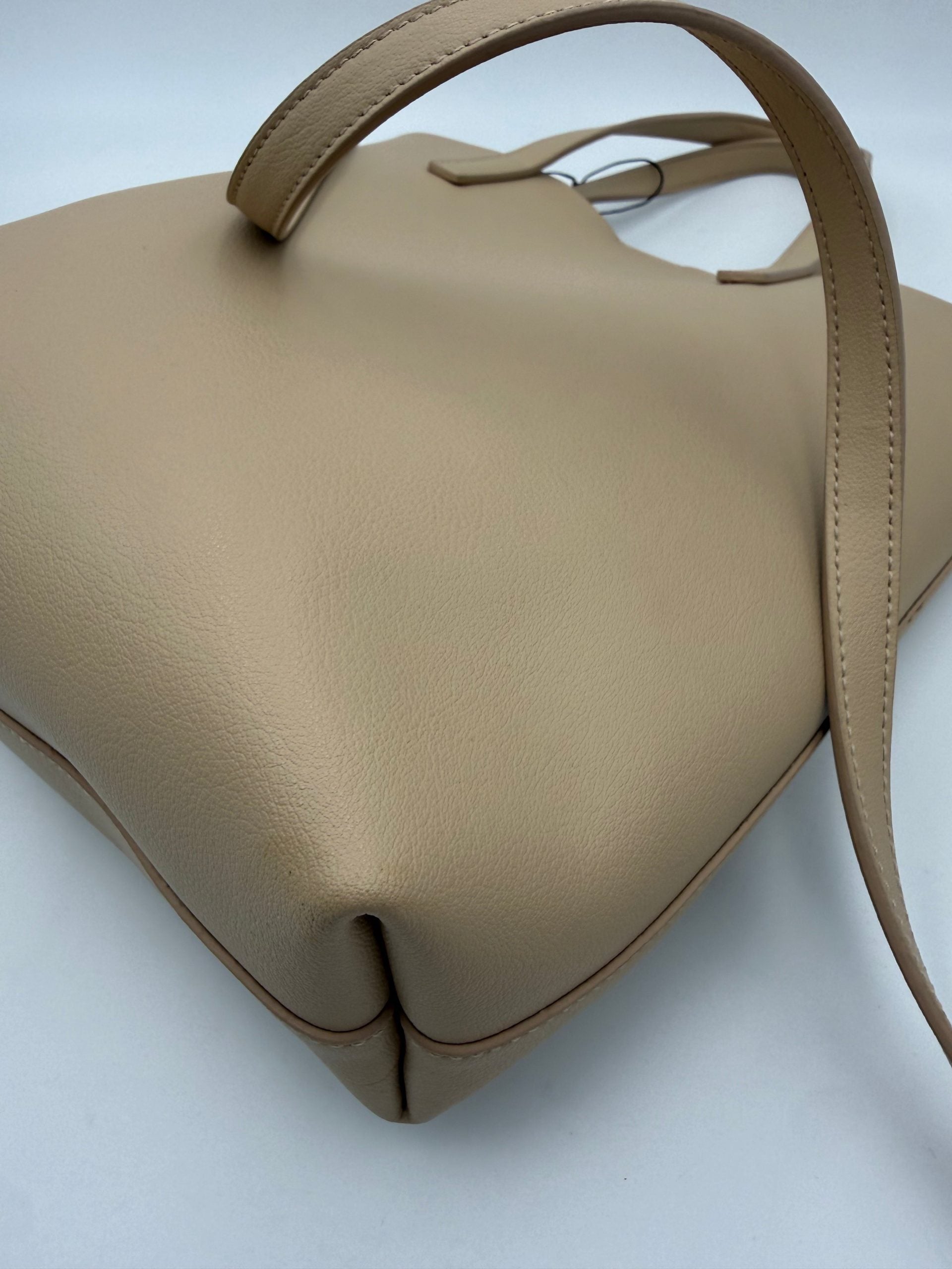 Elevate your style with the Saint Laurent SAINT LAURENT SHOPPING Beige Bag, a masterpiece of fine calf leather and golden accents, embodying timeless luxury and sophistication.