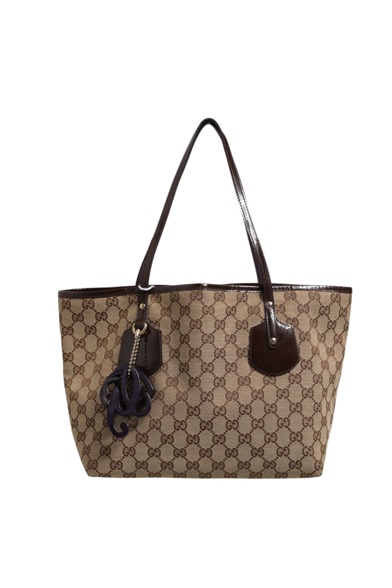 Indulge in the elegance of the Gucci Beige Canvas Medium Jolie Charm Tote Bag, a testament to luxury craftsmanship that enhances your style with timeless sophistication.