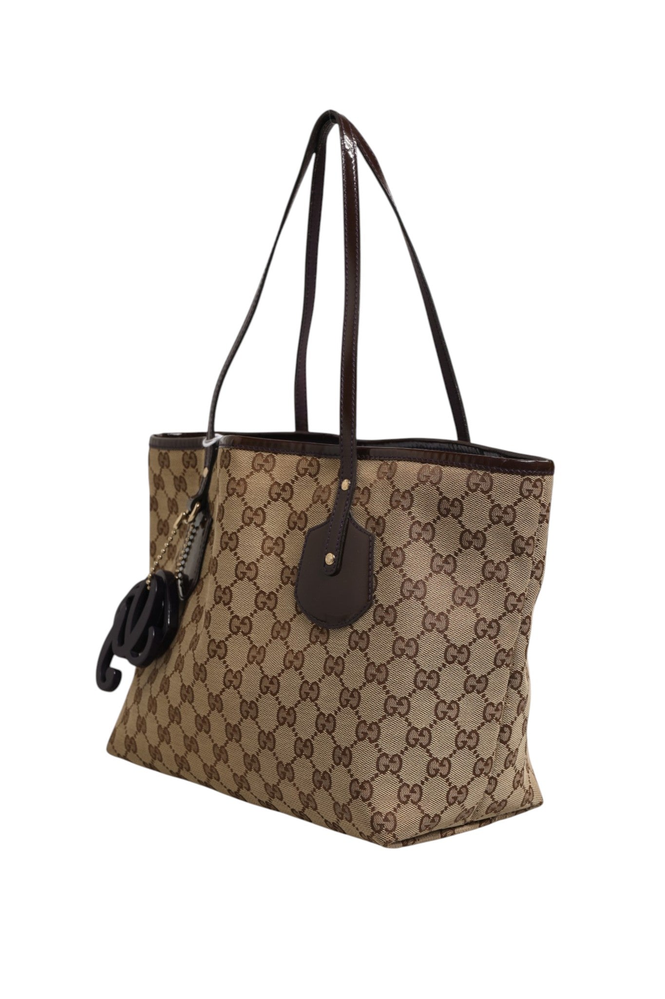 Discover the Gucci Beige Canvas Medium Jolie Charm Tote Bag, a timeless blend of luxury and sophistication, designed for those who appreciate exquisite craftsmanship and style.