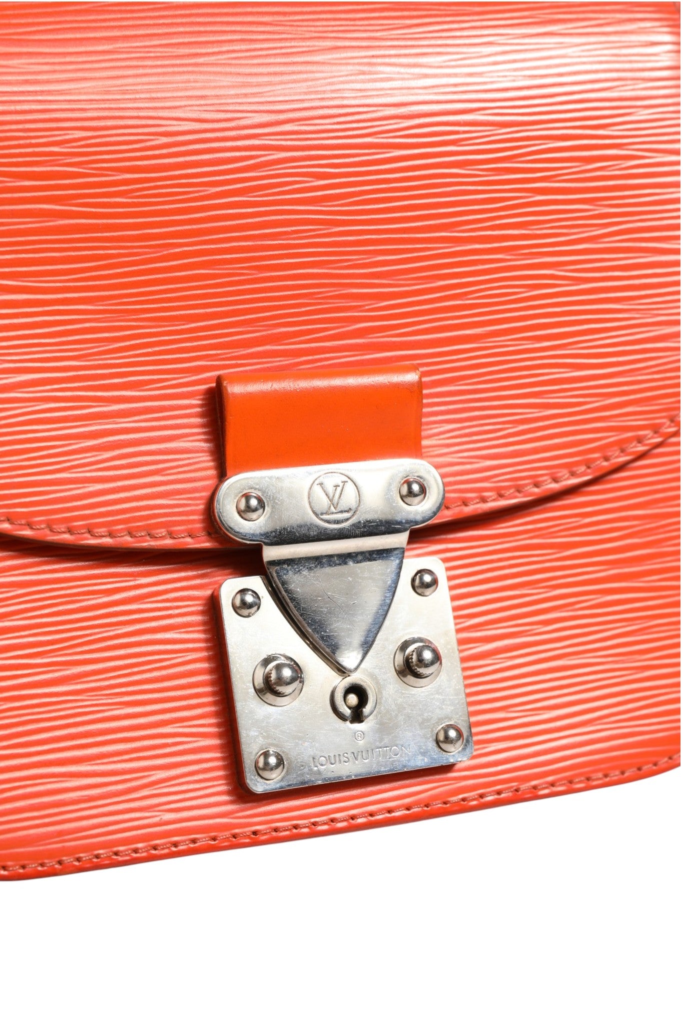 Indulge in the elegance of the Louis Vuitton Epi Leather Eden PM Bag, a masterpiece of craftsmanship in vibrant orange, perfect for elevating any ensemble with timeless luxury.