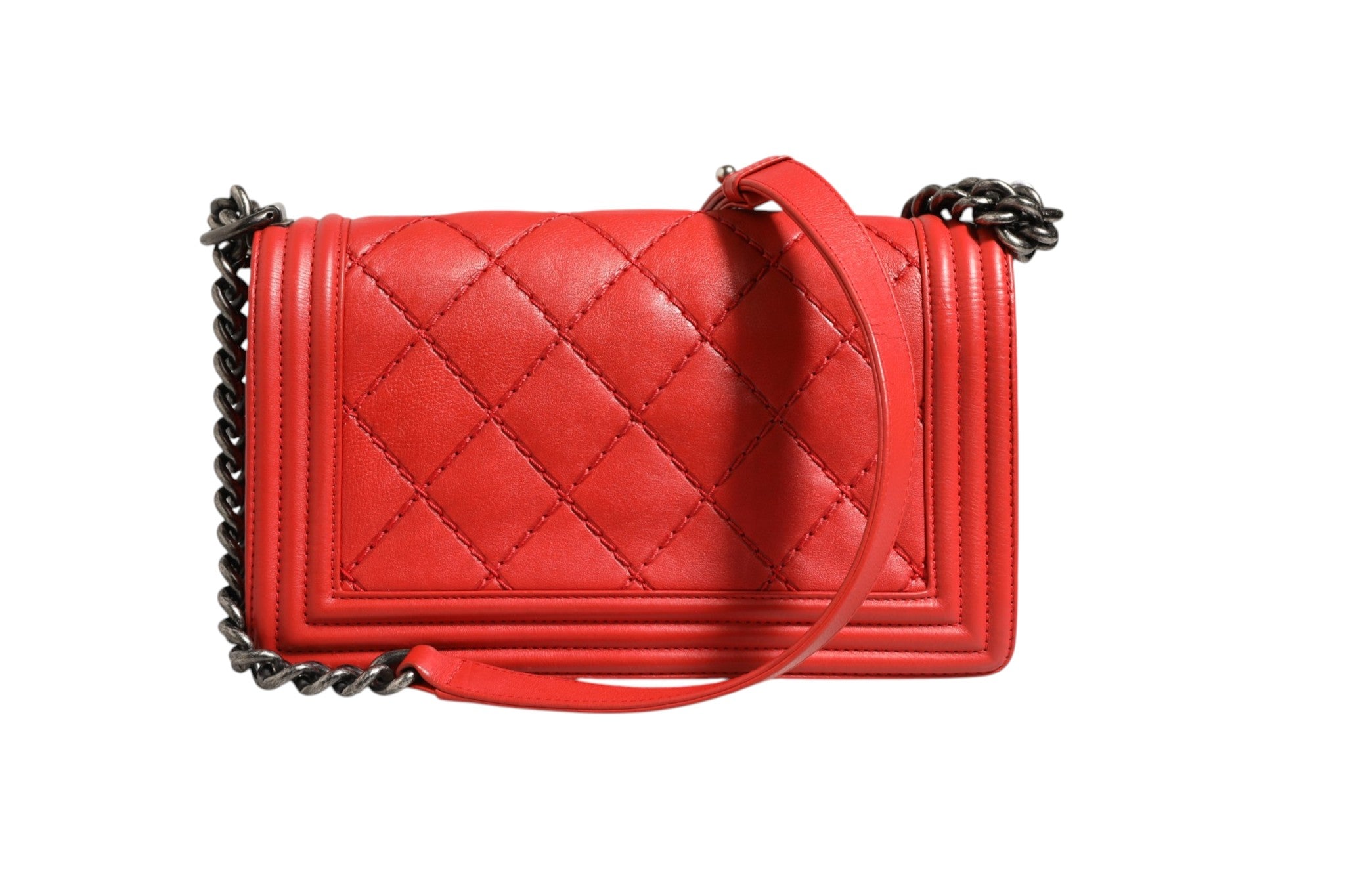 Experience the allure of the Chanel Red Diamond Stitch Calfskin Leather New Medium Boy Bag, a symbol of exquisite craftsmanship and timeless elegance, perfect for any occasion.