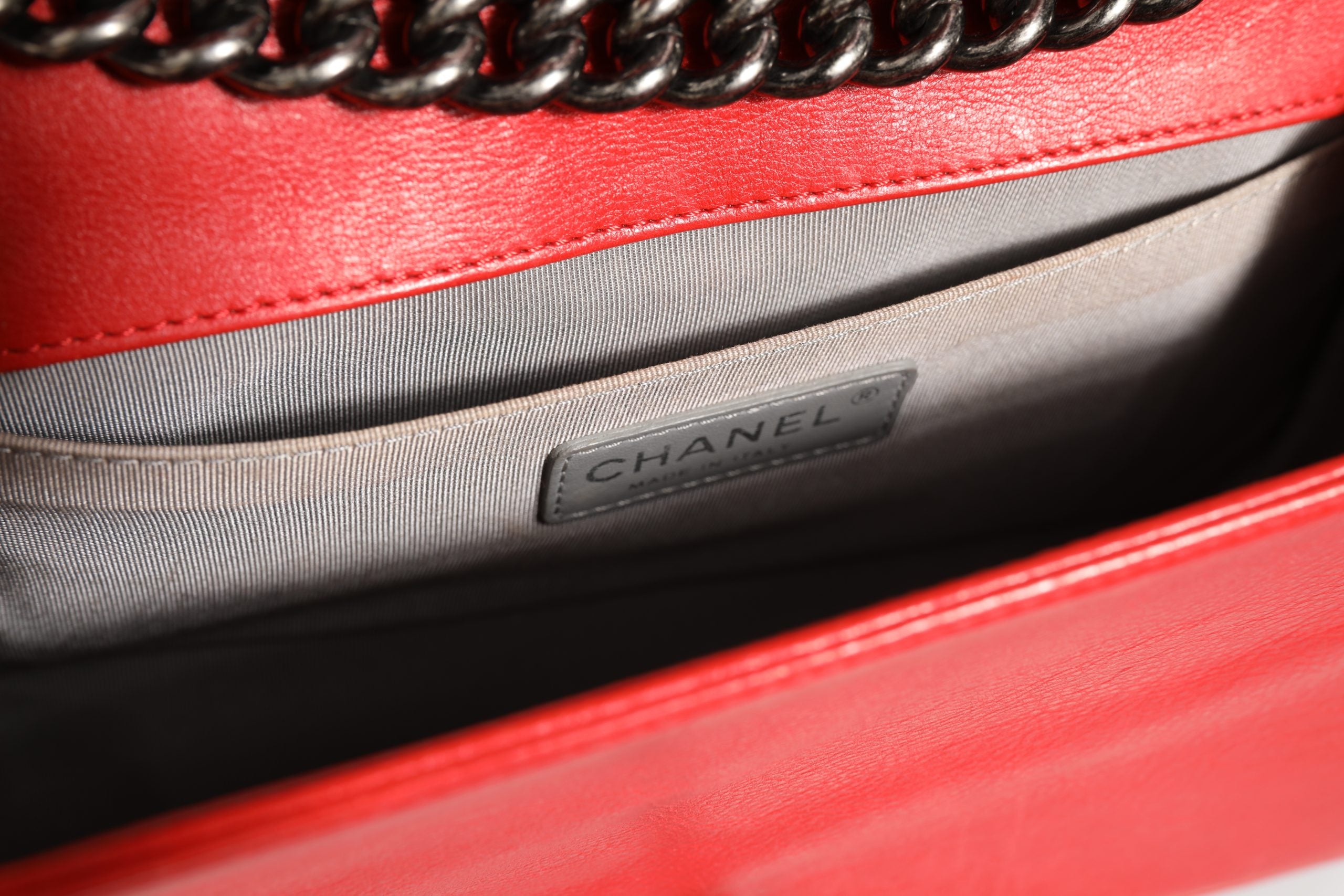 Experience the allure of the Chanel Red Diamond Stitch Calfskin Leather New Medium Boy Bag, where exquisite craftsmanship meets timeless elegance, perfect for any sophisticated occasion.
