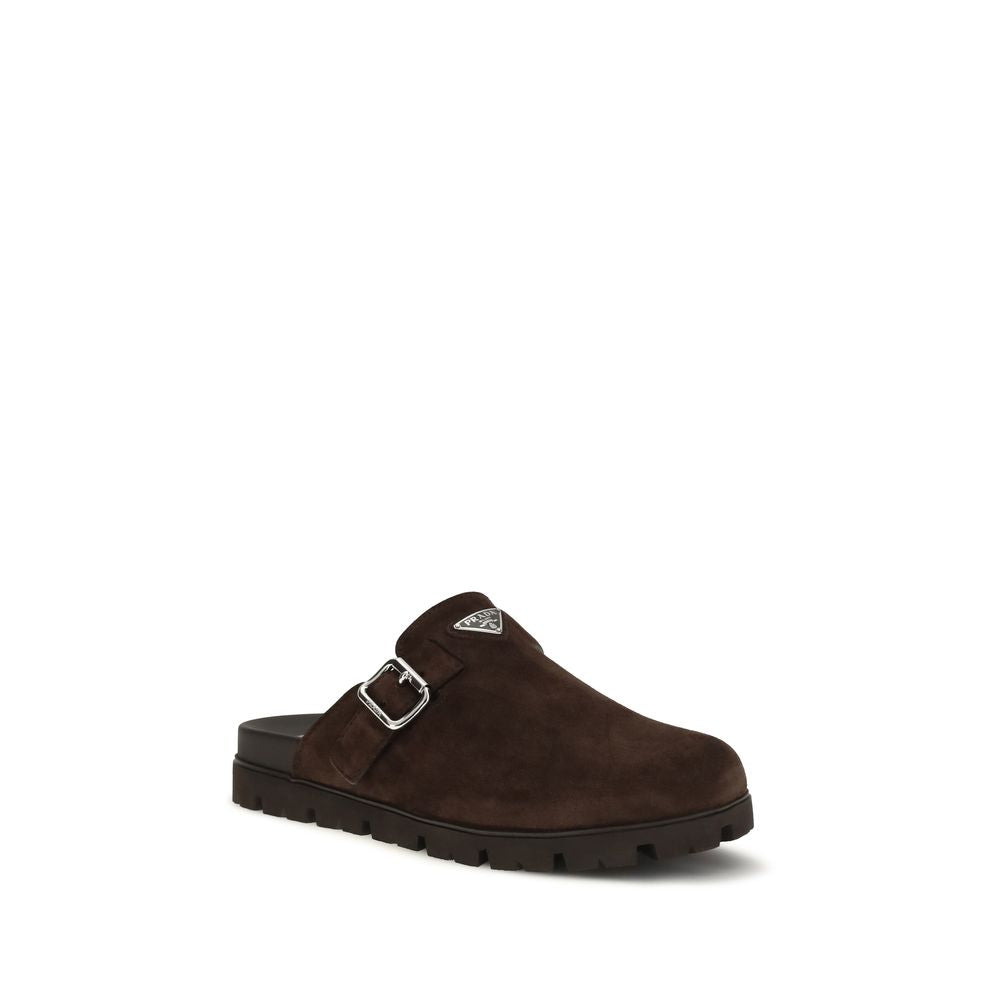 Experience the exquisite Prada Brown Calf Leather Bos Taurus Mules, where luxurious craftsmanship meets minimalist elegance, perfect for the discerning fashion aficionado.