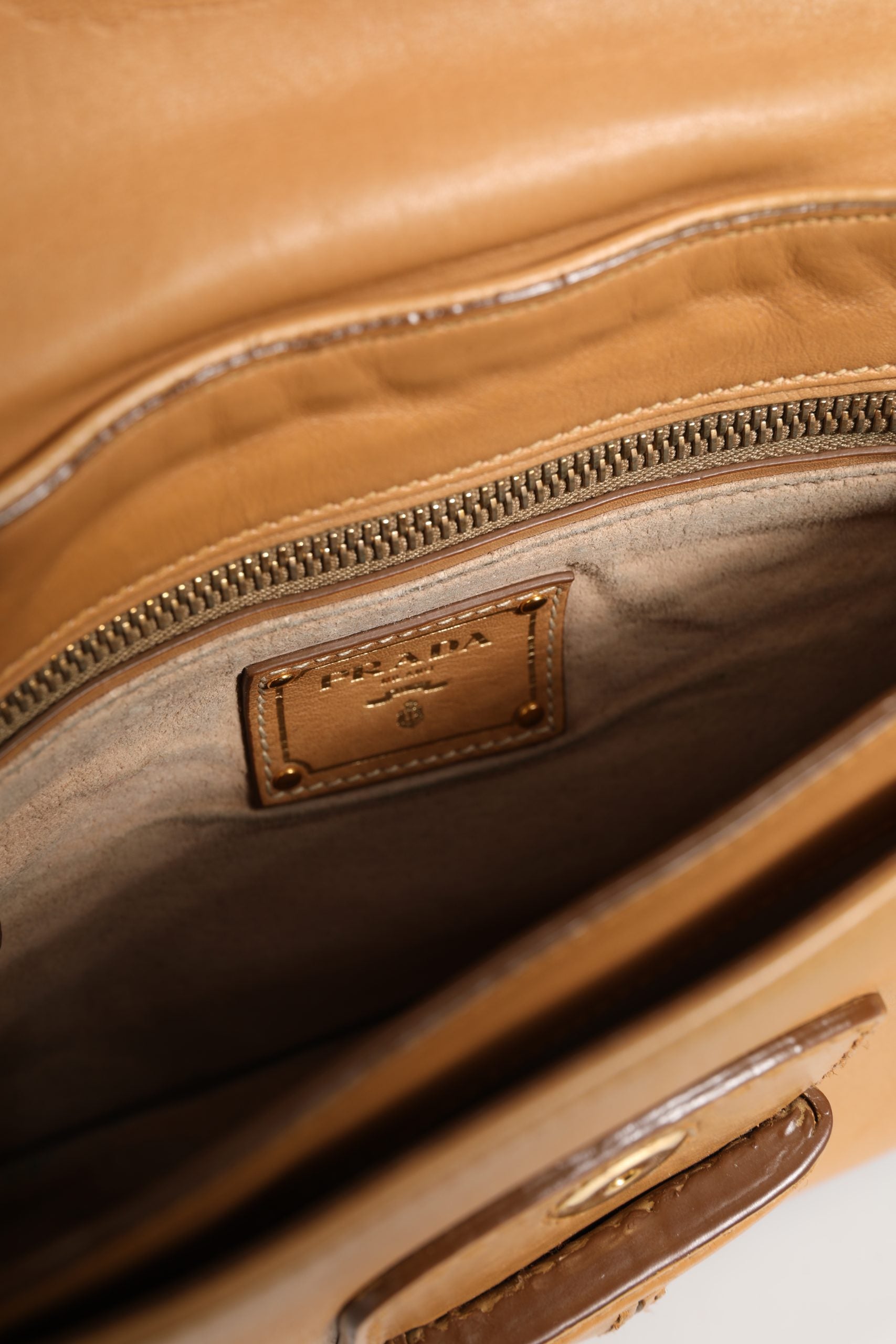 Indulge in the Prada Sidonie Beige Pebble Leather Shoulder Bag, a symbol of refined craftsmanship and timeless elegance, perfect for elevating any sophisticated ensemble.