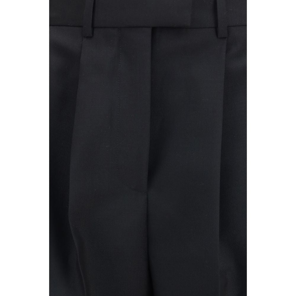 Elevate your wardrobe with Givenchy Black Wool Oves Aries Dress Pants, a masterpiece of luxurious craftsmanship blending 73% Wool Ovis Aries and 27% Mohair for timeless elegance.