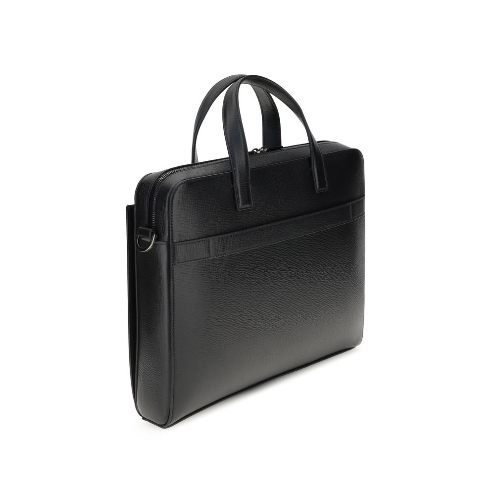 Elevate your professional presence with the Ferragamo Black Calf Leather Bos Taurus Briefcase, a blend of exquisite craftsmanship and timeless elegance, perfect for the discerning individual.