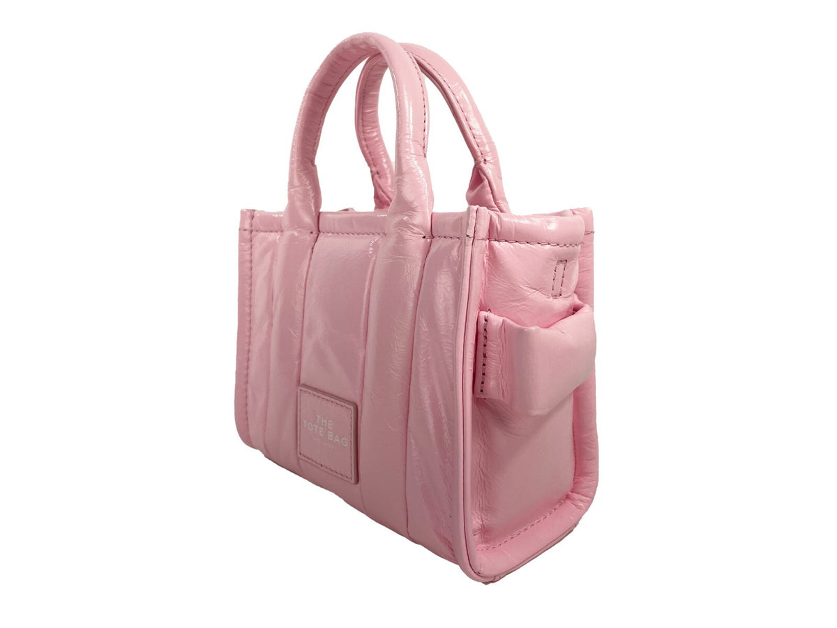 Elevate your style with Marc Jacobs The Shiny Crinkle Micro Tote, a luxurious patent leather masterpiece that embodies contemporary sophistication and playful elegance.