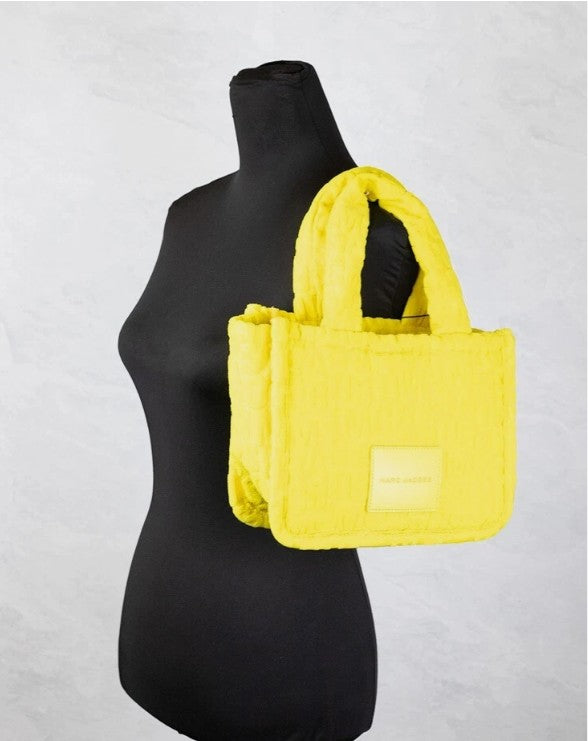 Elevate your style with the Marc Jacobs Monogram Terry Tote in vibrant golden kiwi, a luxurious blend of exquisite craftsmanship and modern elegance for the discerning individual.